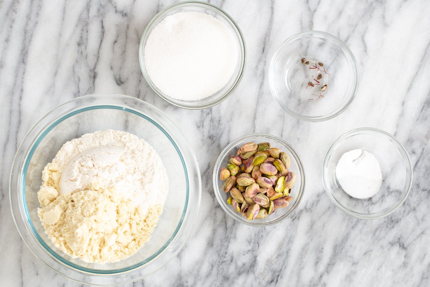 pistachio cookie recipe ingredients for vegan pistachio cookie recipe on a marble kitchen counter