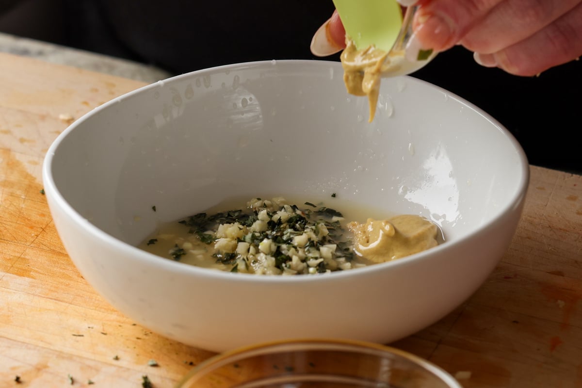 adding mustard to the dressing ingredients