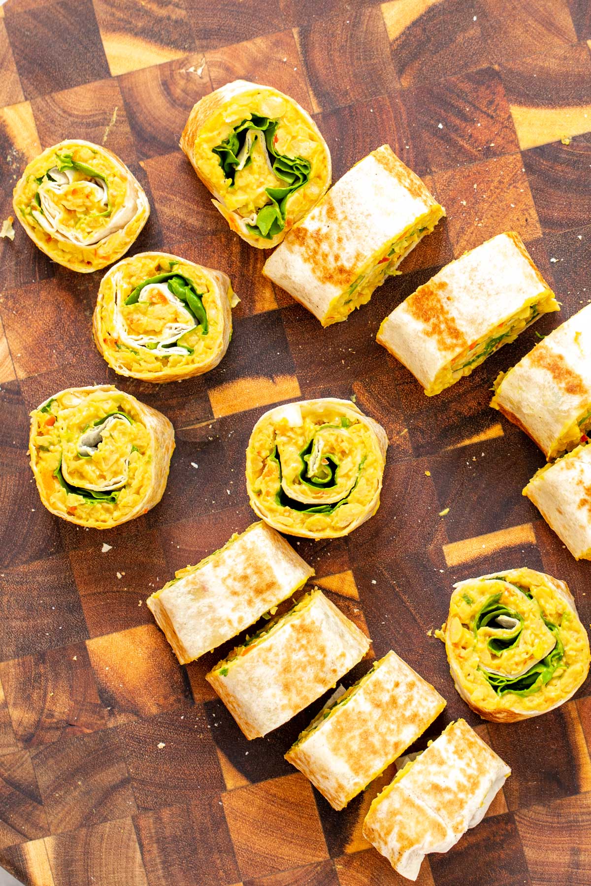 chickpea breakfast  vegan chickpea scramble wraps being sliced into pinwheels