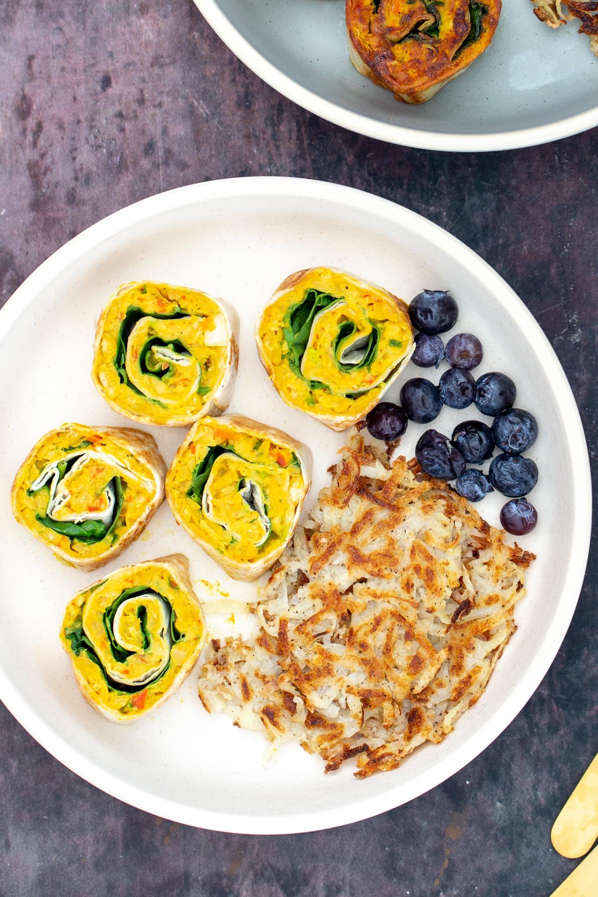 chickpea breakfast  vegan chickpea breakfast rolls served on a plate with blueberries and hashbrowns