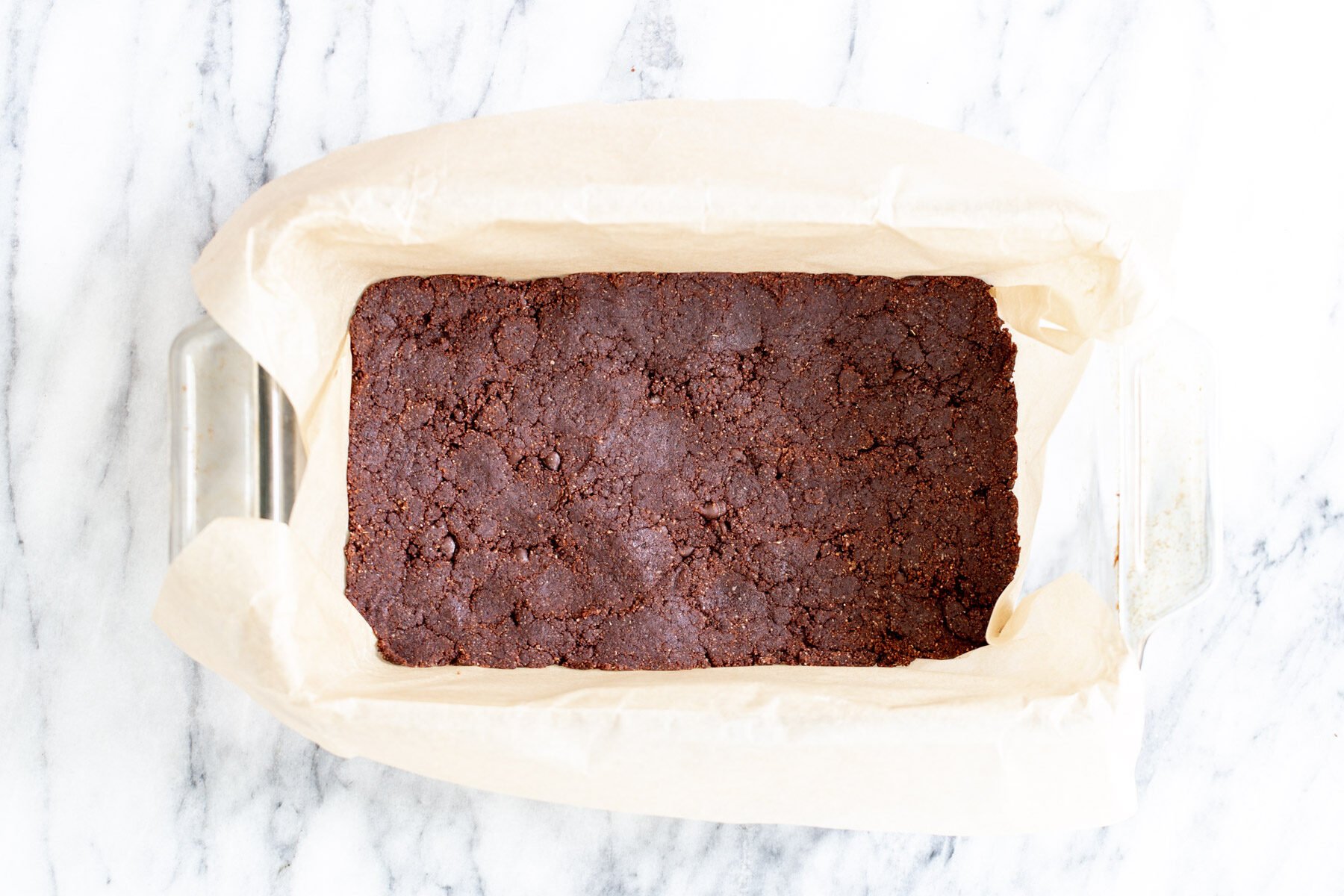 vegan cookie dough pressed into a loaf pan to make vegan ice cream sandwiches
