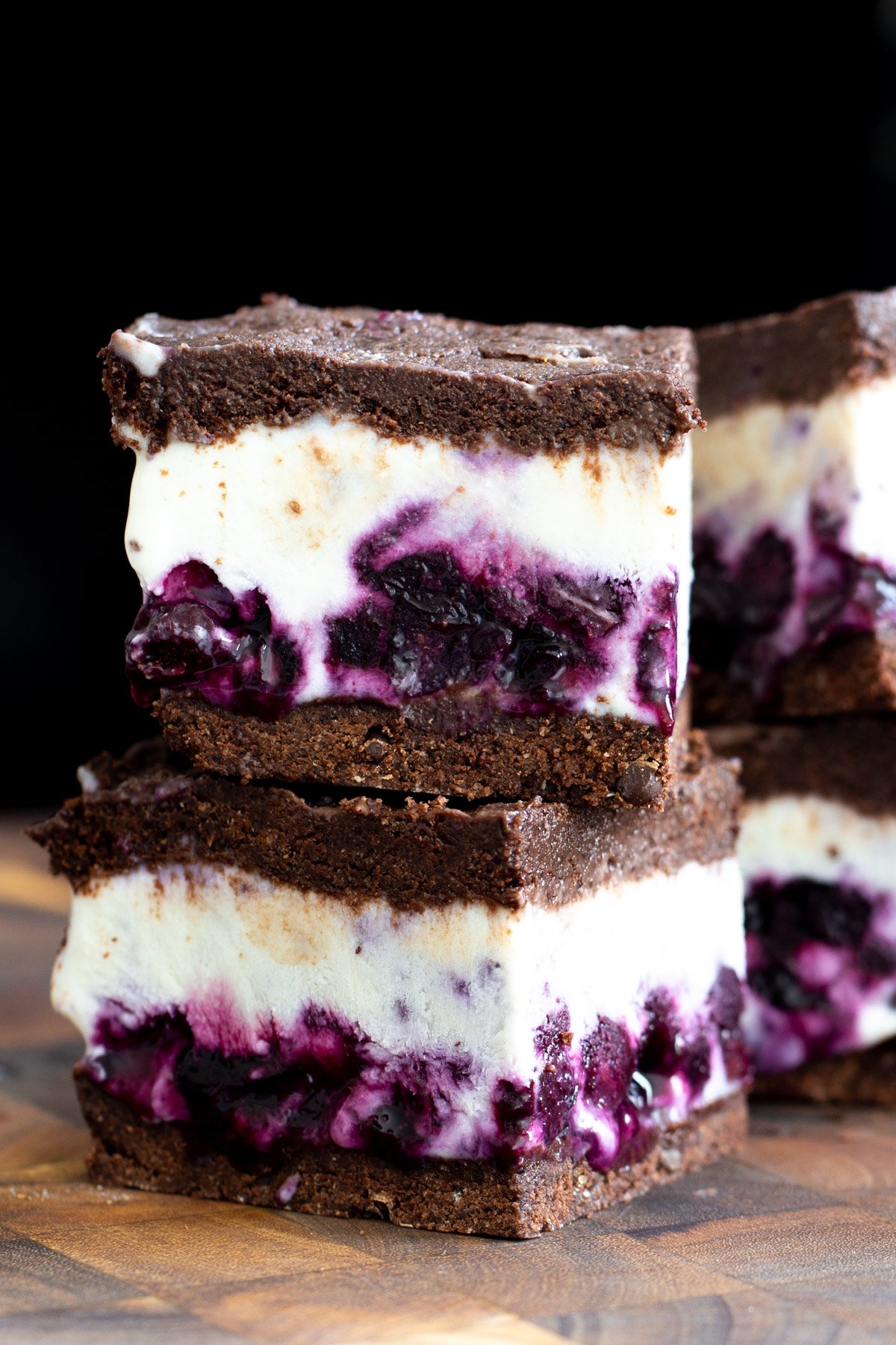 vanilla ice cream sandwiches close-up of two stacked vegan chocolate vanilla ice cream sandwiches with blueberry swirl