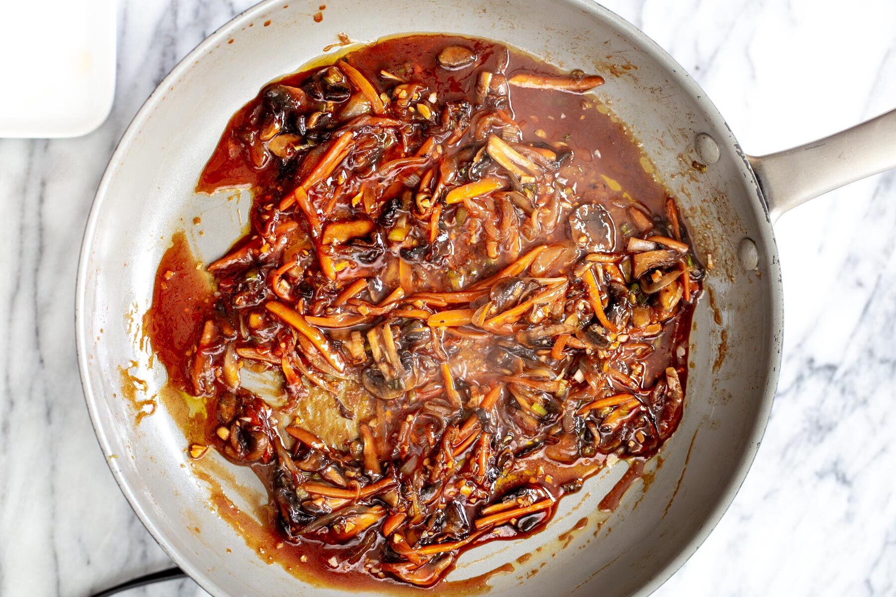 gochujang sauce veggies in a saucepan simmering with sauce ingredients