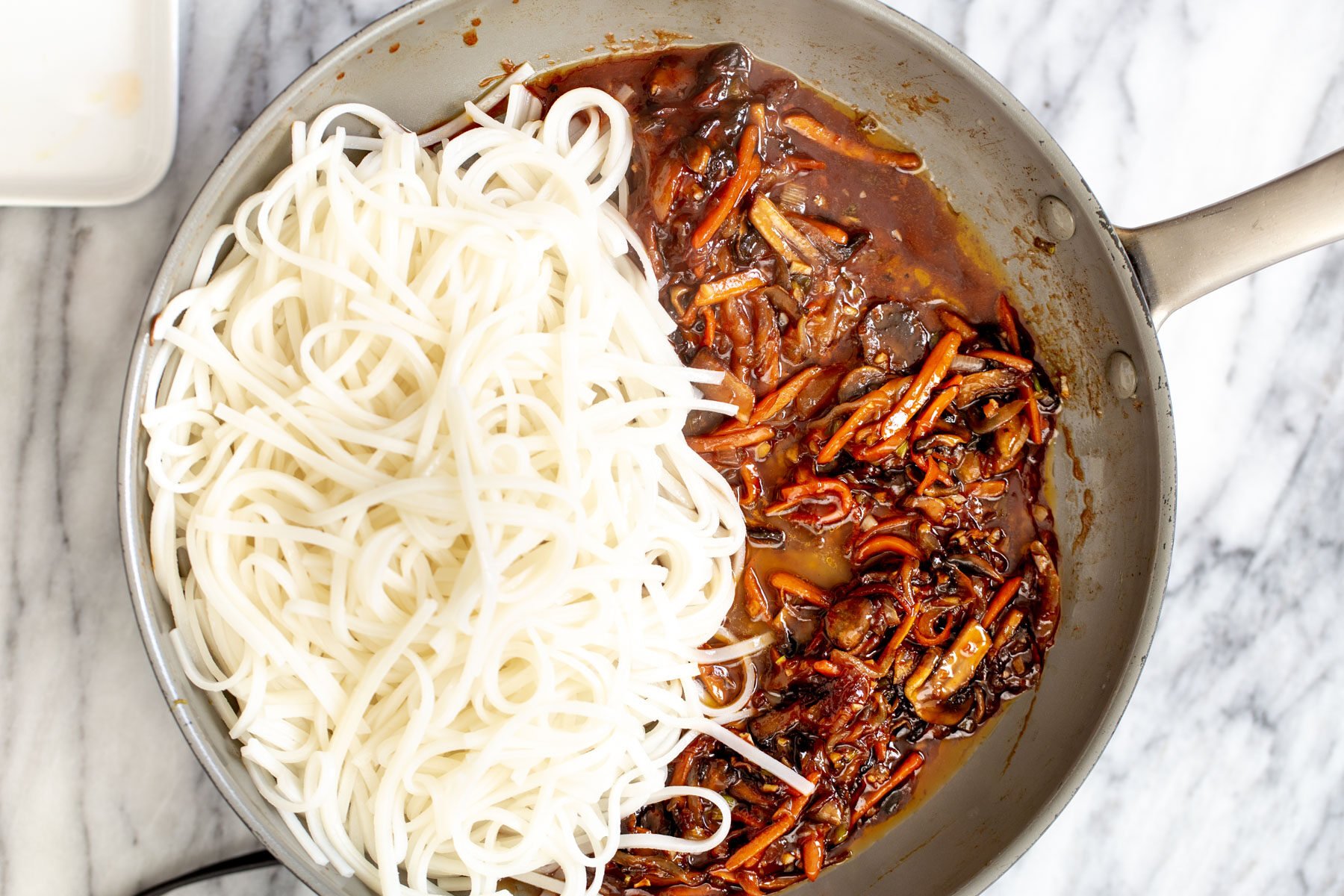 gochujang noodles  cooked rice noodles and veggies with Korean stir-fry sauce in a saucepan