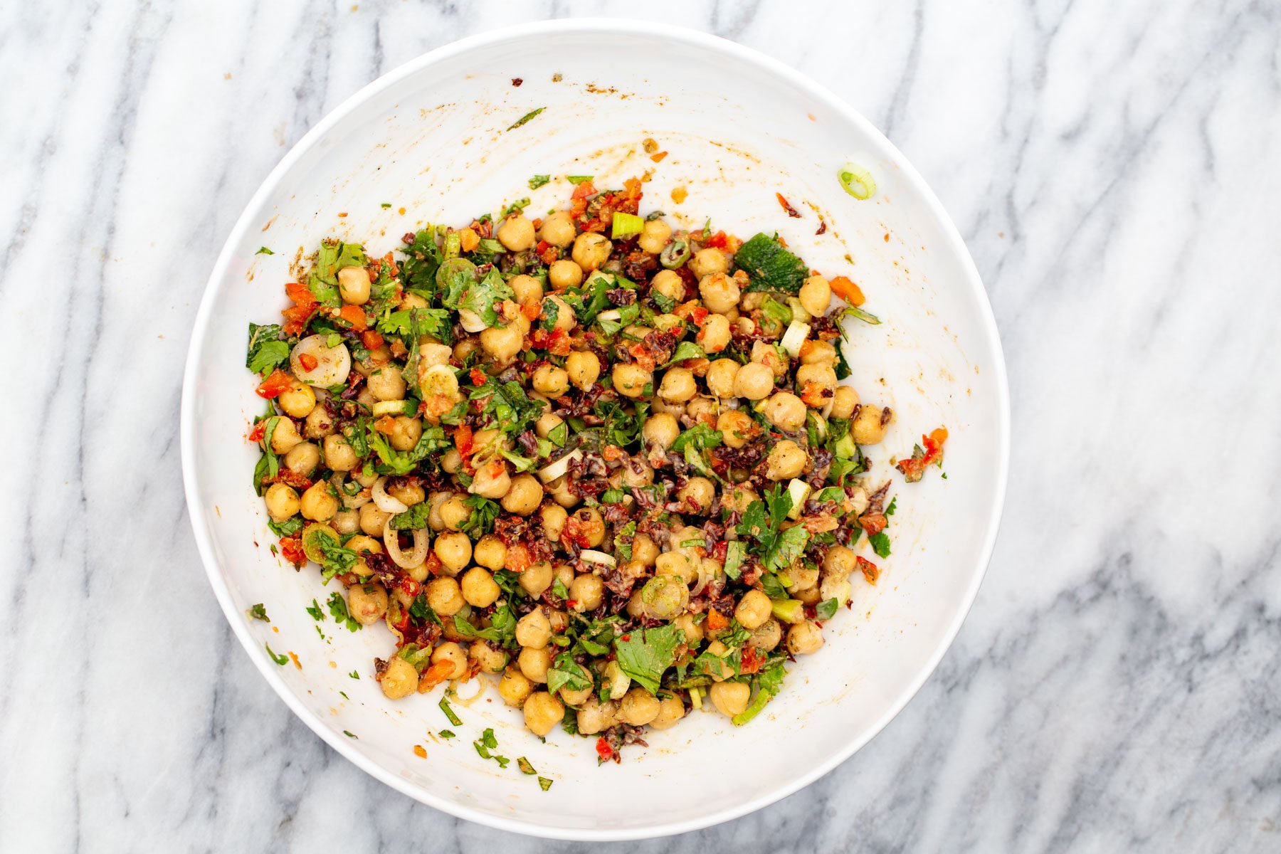 Chickpeas tossed with chopped veggies, spices and Mediterrenean herbs for chickpea salad