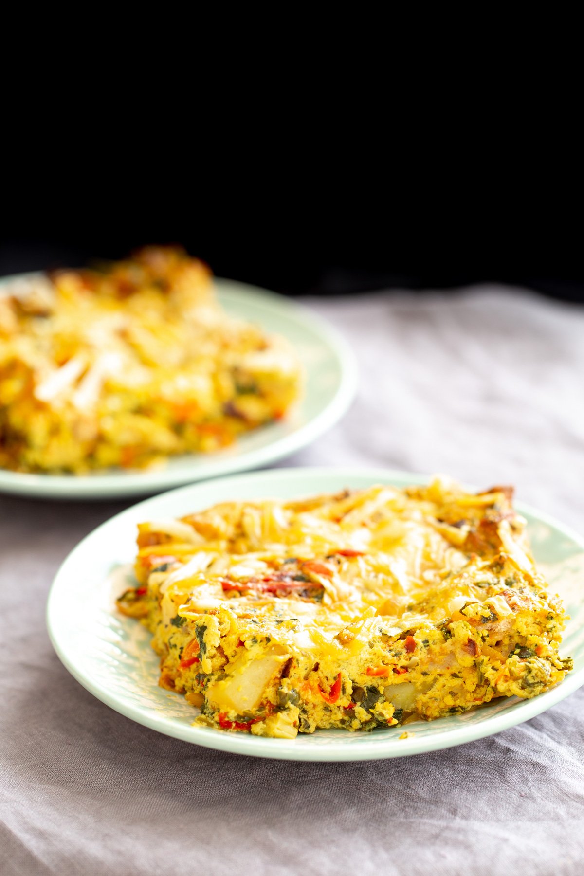 Vegan Mexican casserole a plate with Mexican egg casserole topped with shredded cheese