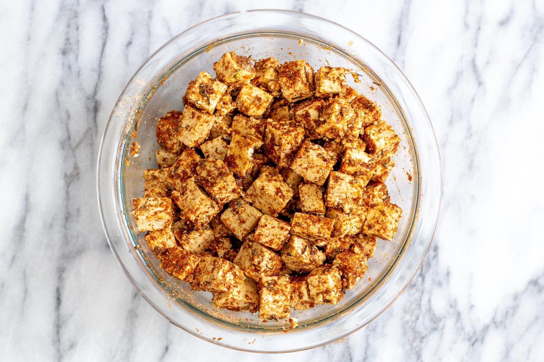 blackened tofu tacos tofu cubes tossed with spices in a glass bowl