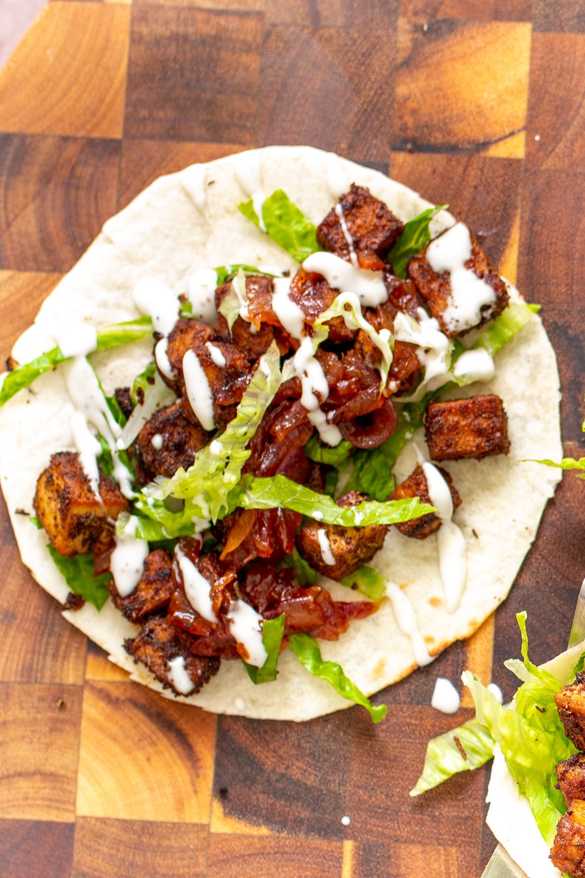 blackened tofu taco tortilla topped with blackened tofu, caramelized onion and sour cream