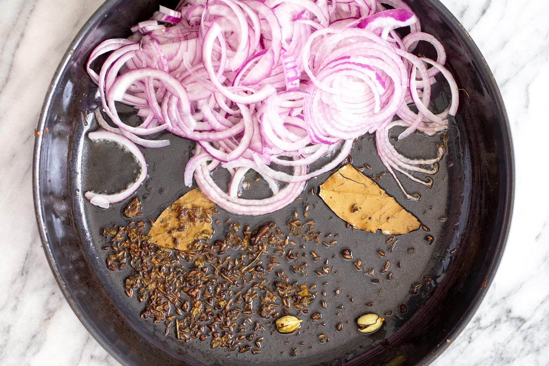 onions, and spices in a black skillet