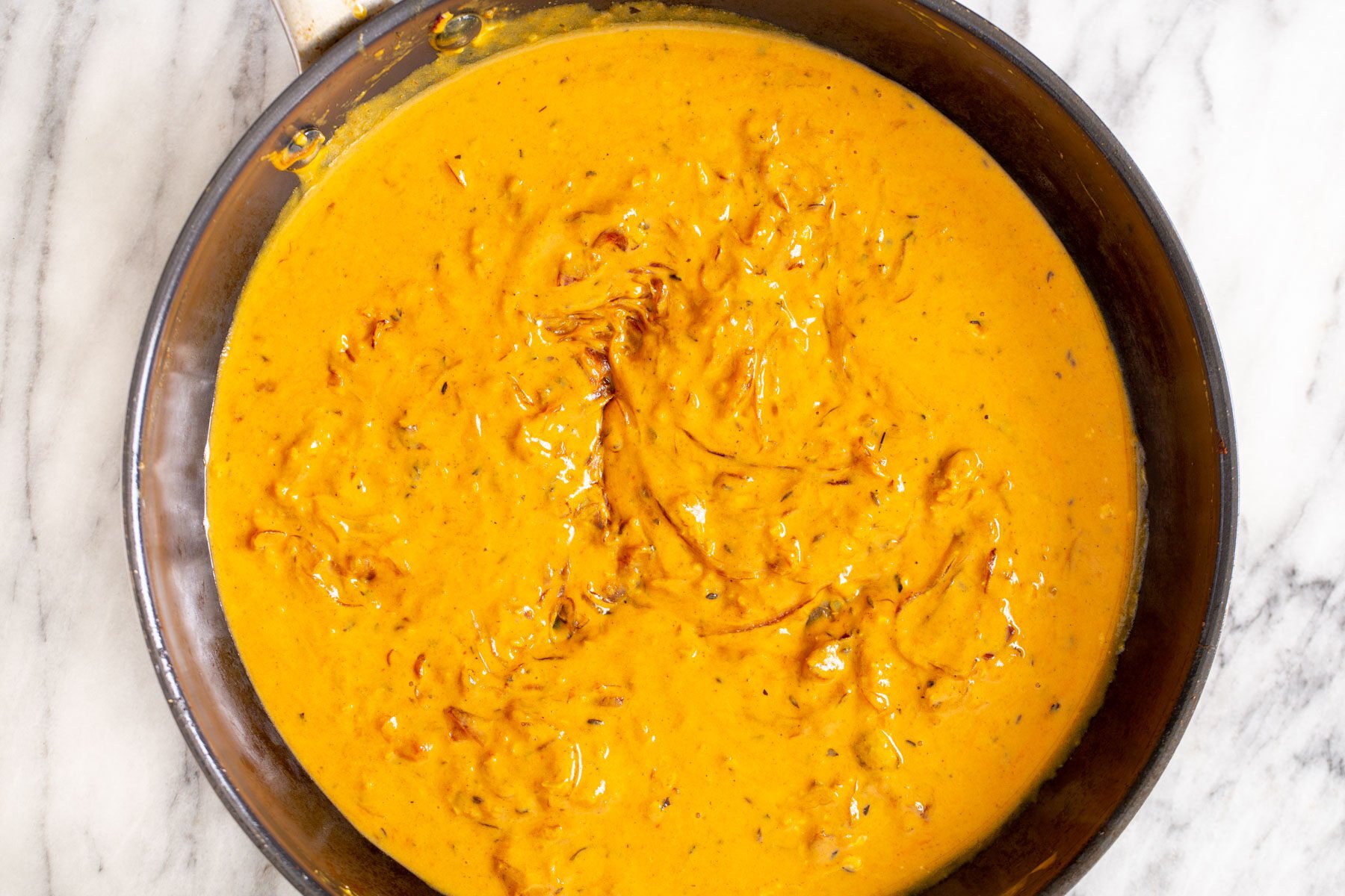 cauliflower in tomato yogurt gravy in a black skillet