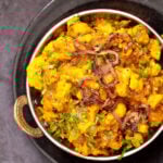 cauliflower in onion sauce in a black skillet