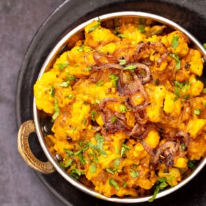 cauliflower in onion sauce in a black skillet