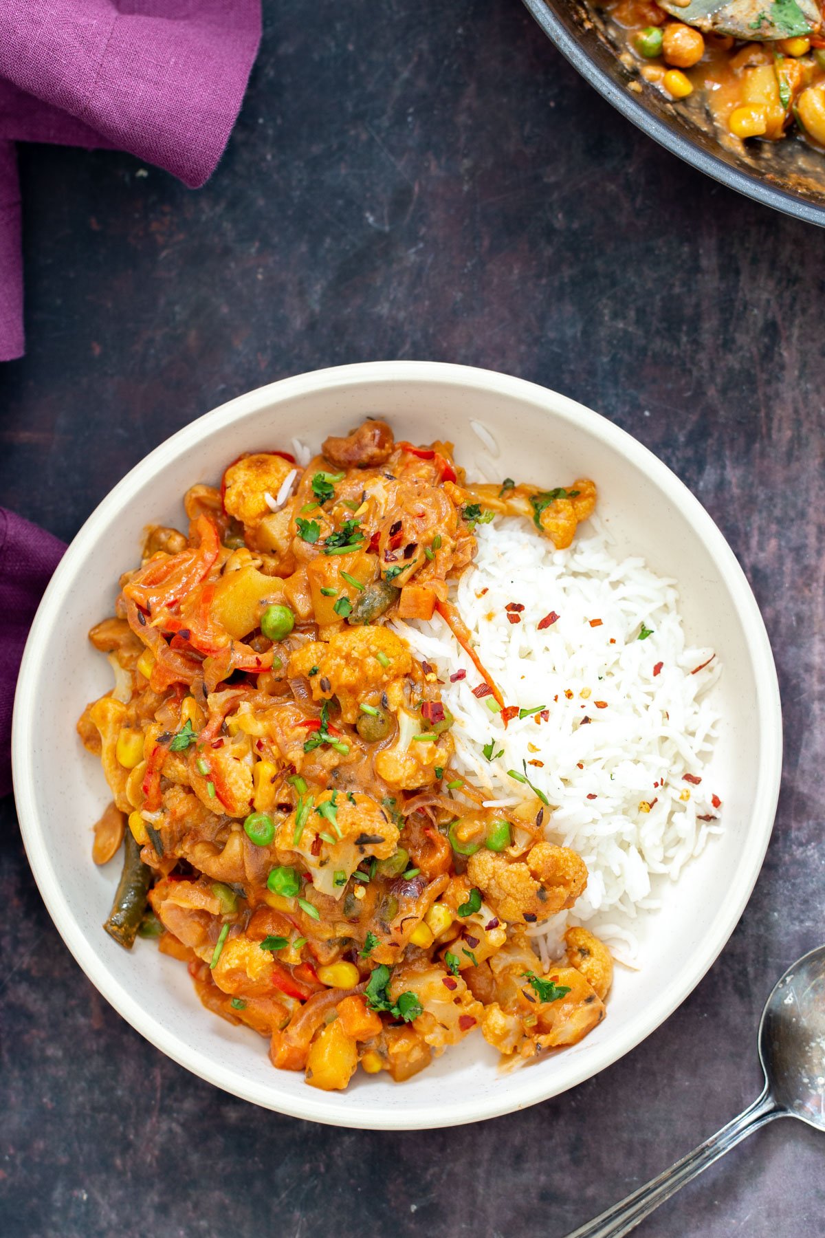 diwani handi  diwani handi vegetables in a white bowl served with a side of rice