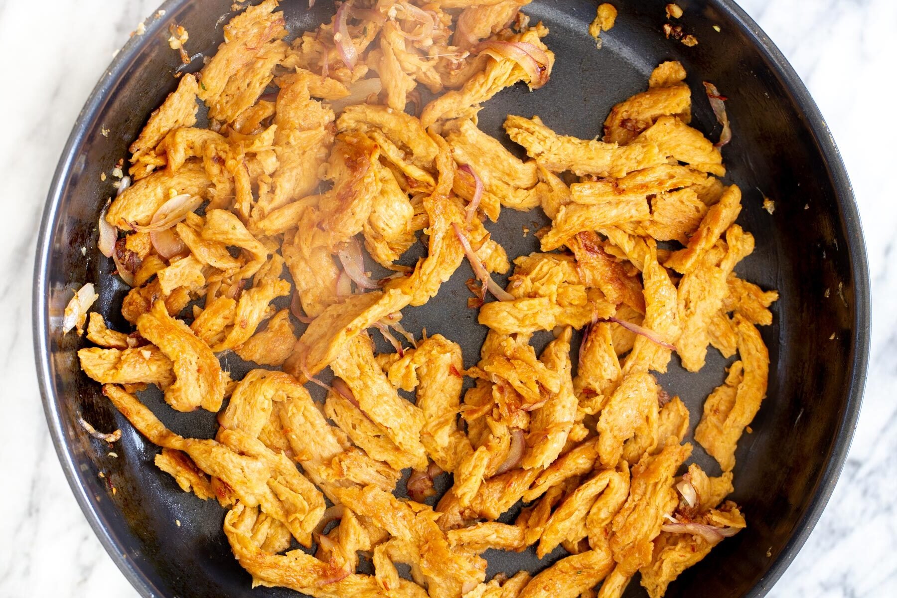 marinated soy chunks with garlic in a frying pan