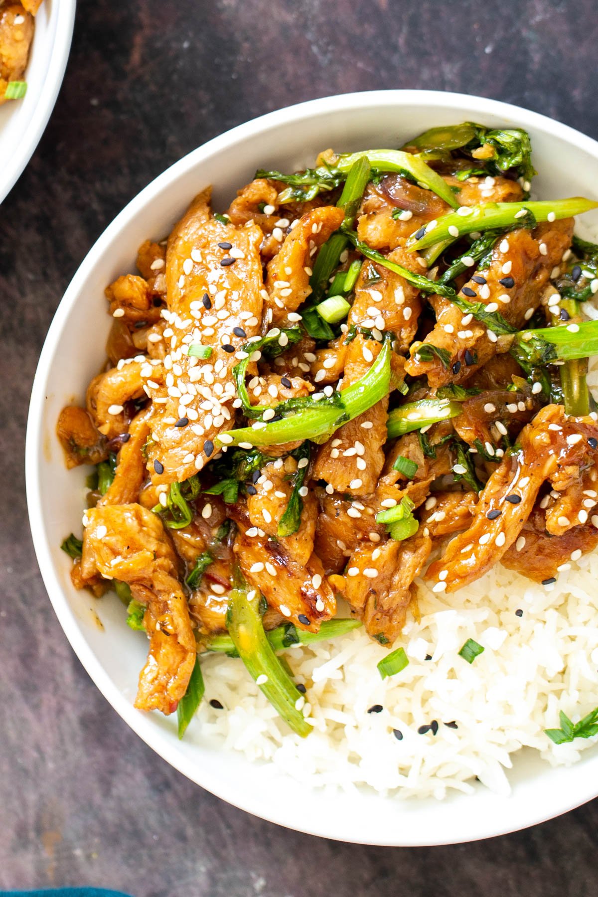 close-up overhead of sesame shallot soy curl stir-fry with broccolini sprinkled with sesame seeds