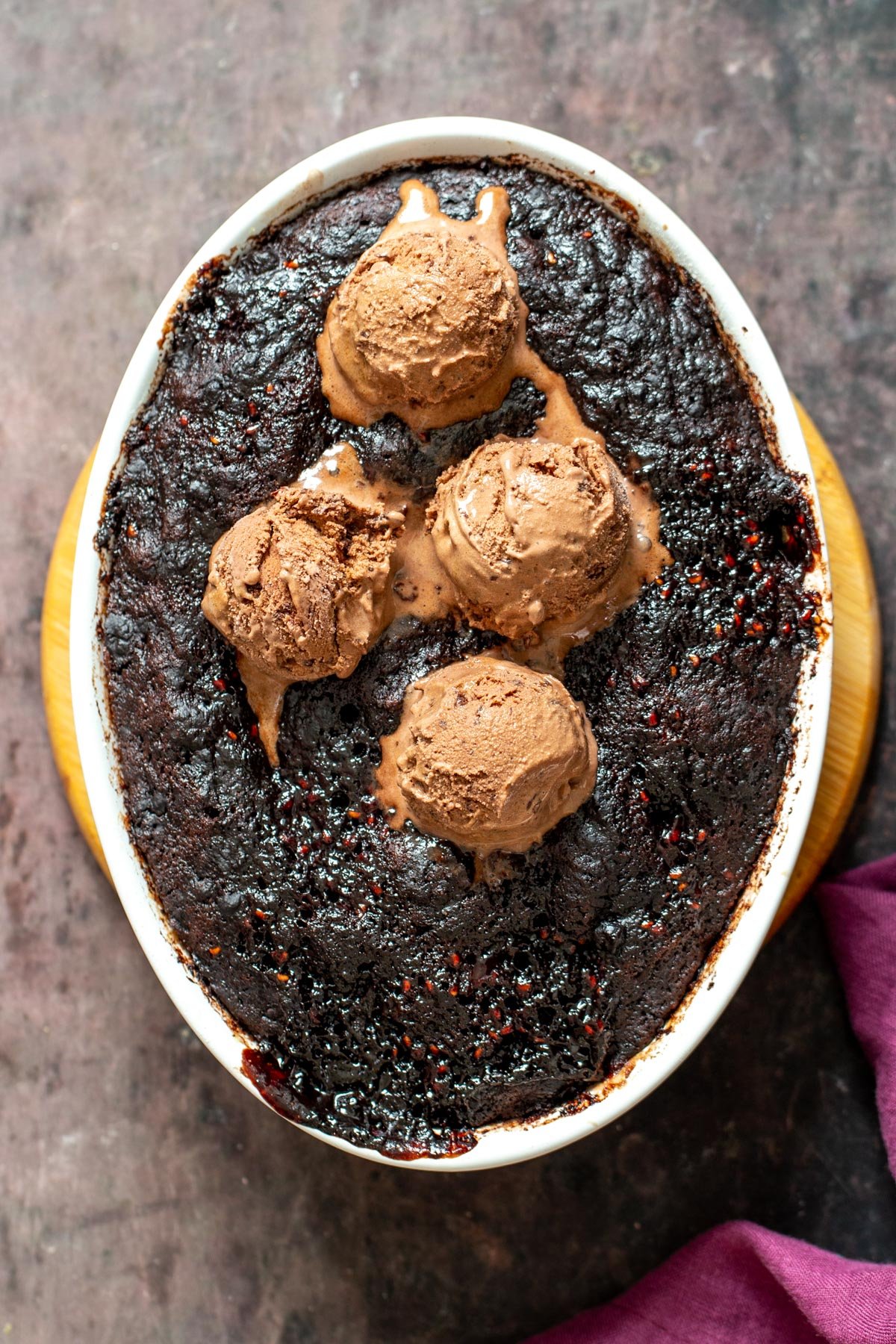 vegan self saucing pudding vegan self saucing chocolate pudding cake in a round casserole dish topped with ice cream