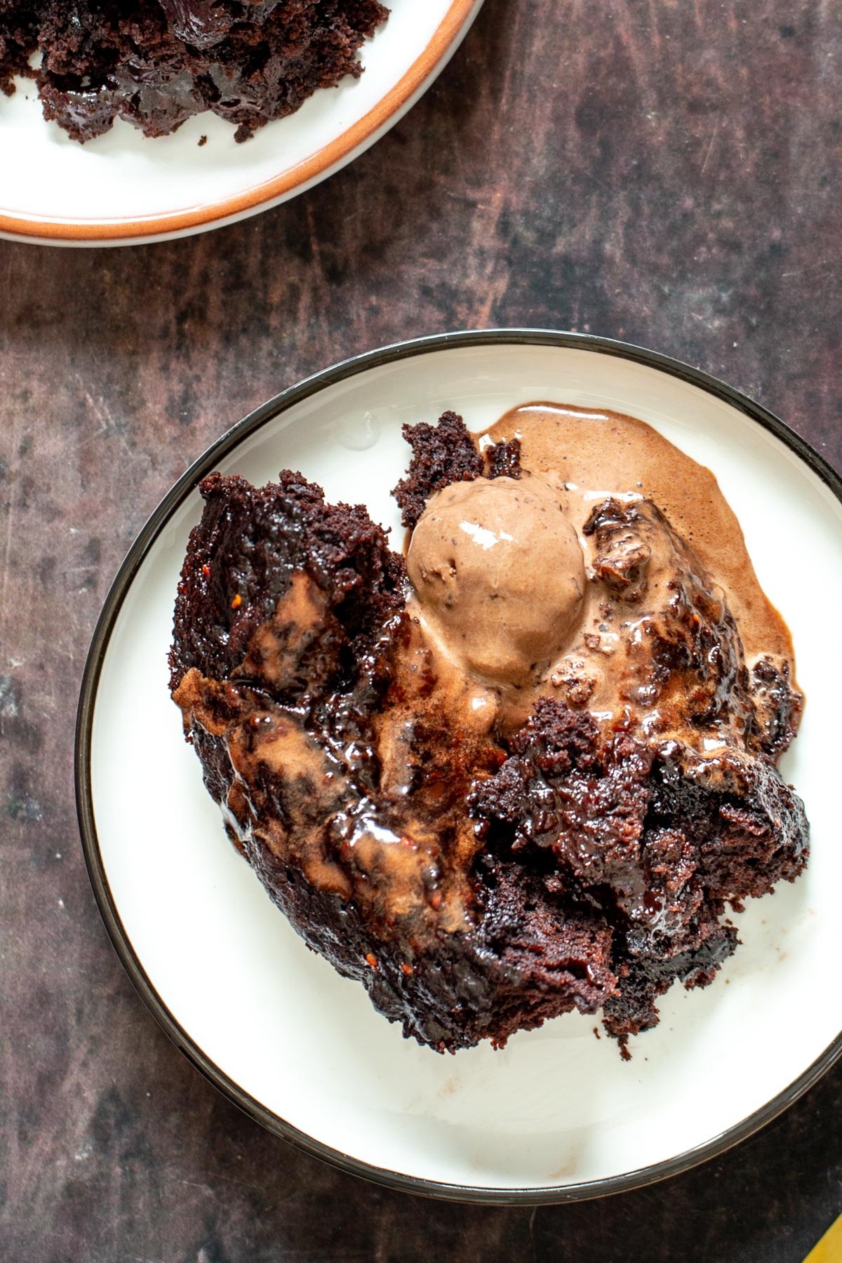 vegan self saucing pudding a serving of chocolate pudding cake served with a scoop of ice cream