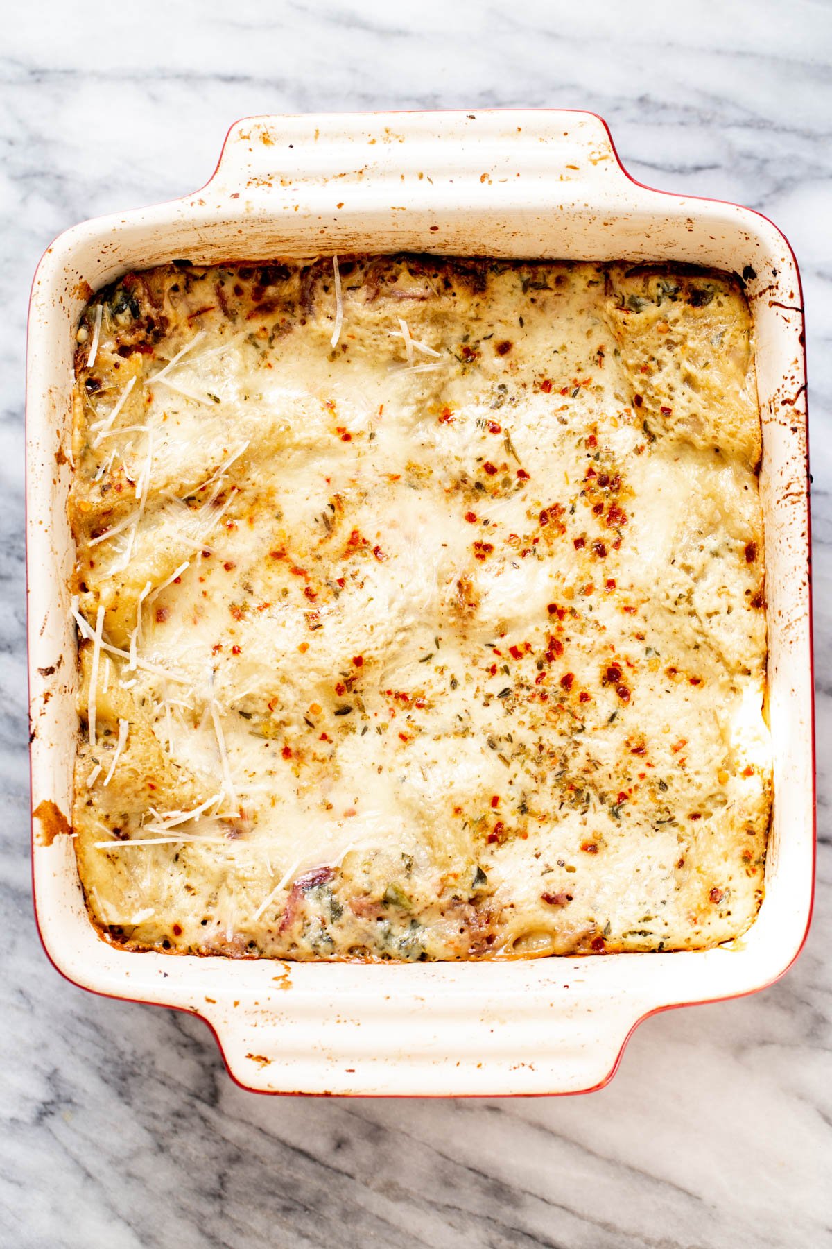 vegan butternut squash lasagna a casserole dish with vegan spinach, onion & butternut squash lasagna