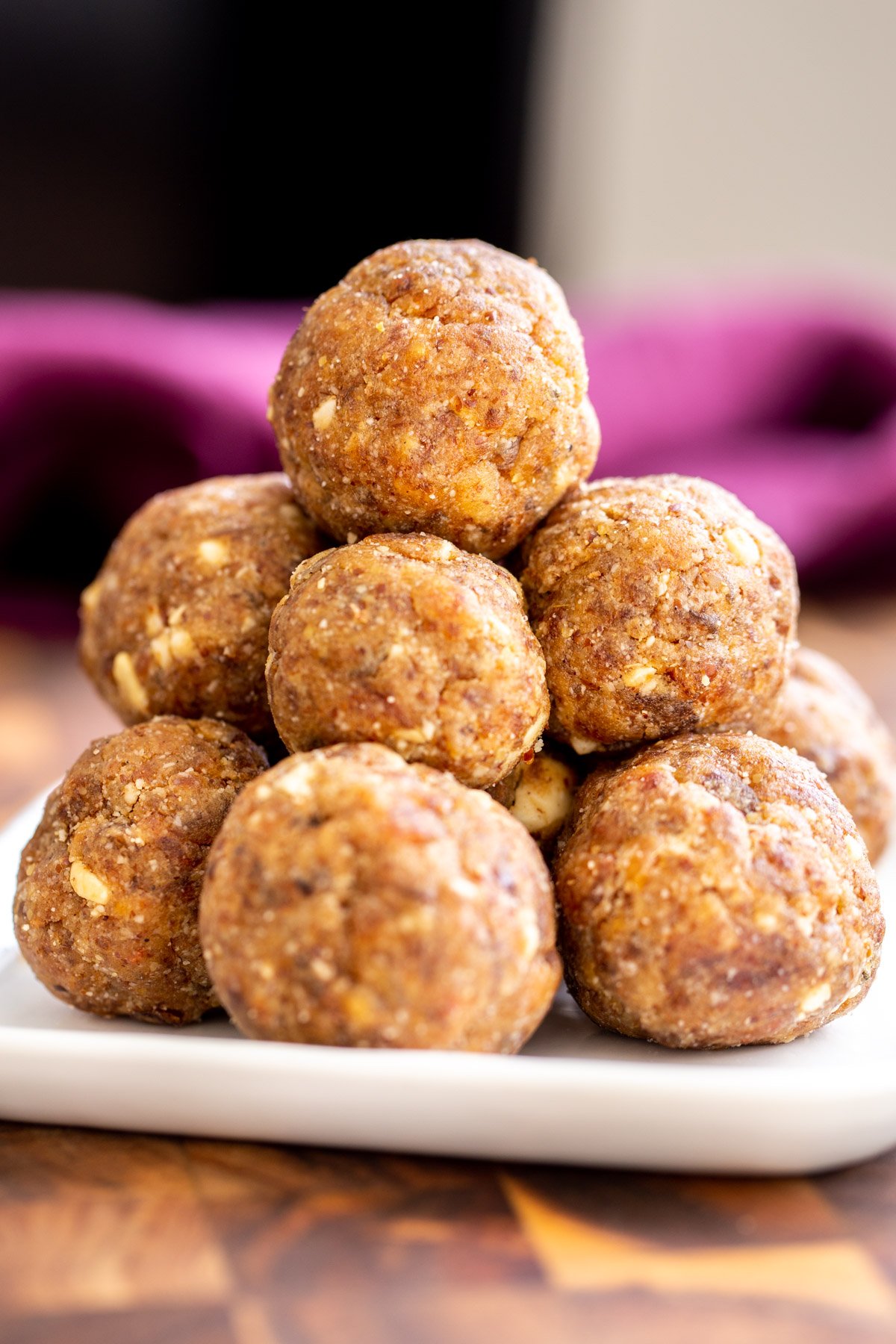 date ladoo a plate with stacked vegan date ladoos