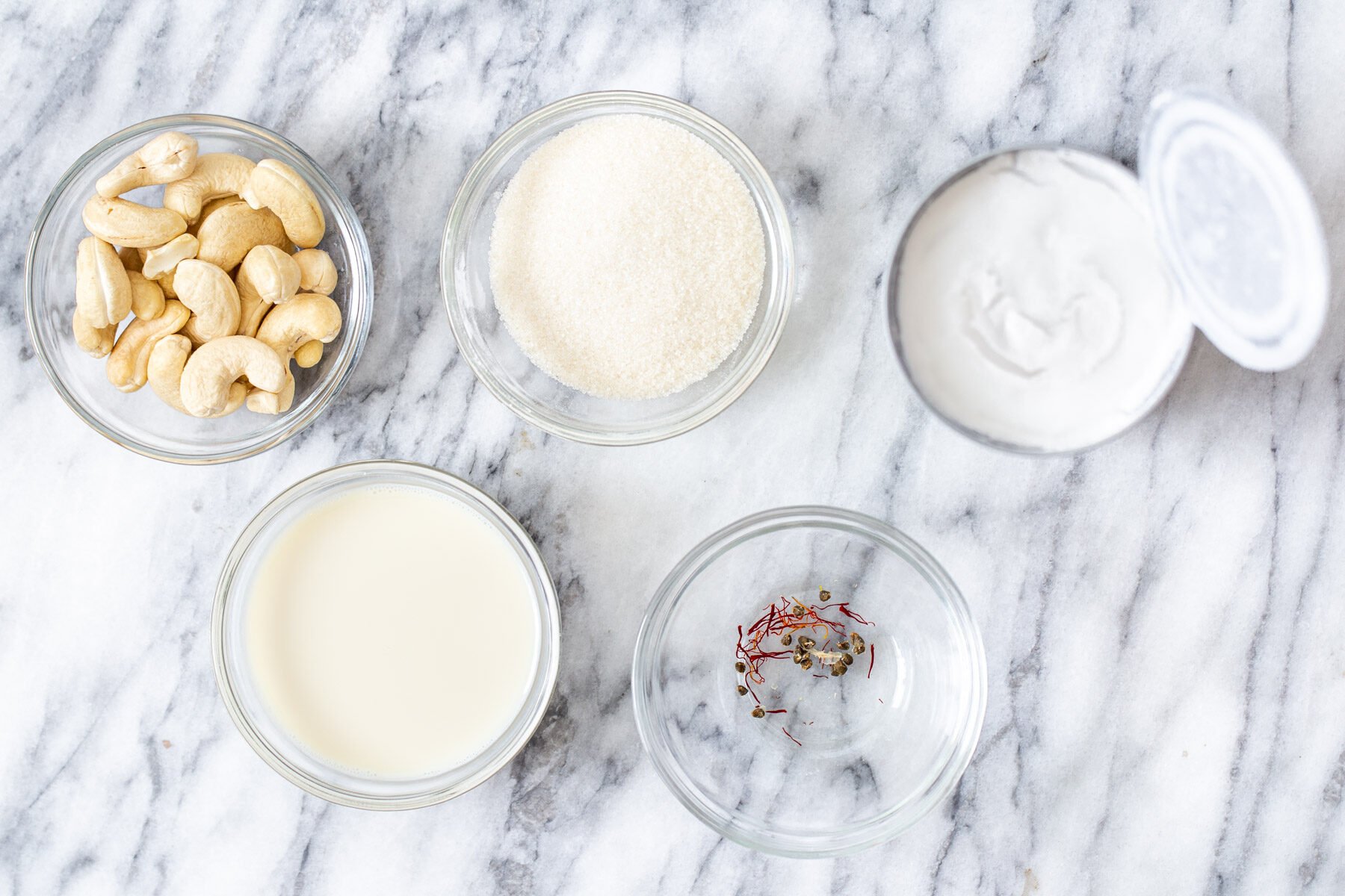 Ingredients for the soaking rasmalai milk in bowls “ class=