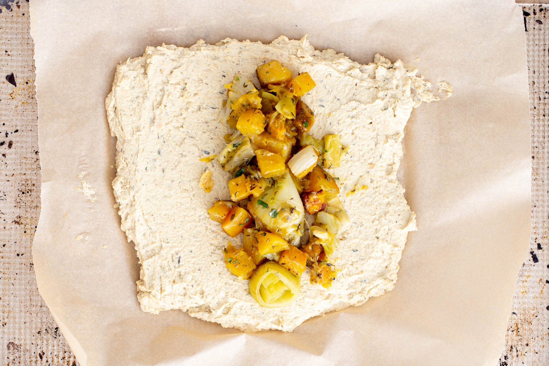 vegan chickpea roast mix being filled with roasted vegetables