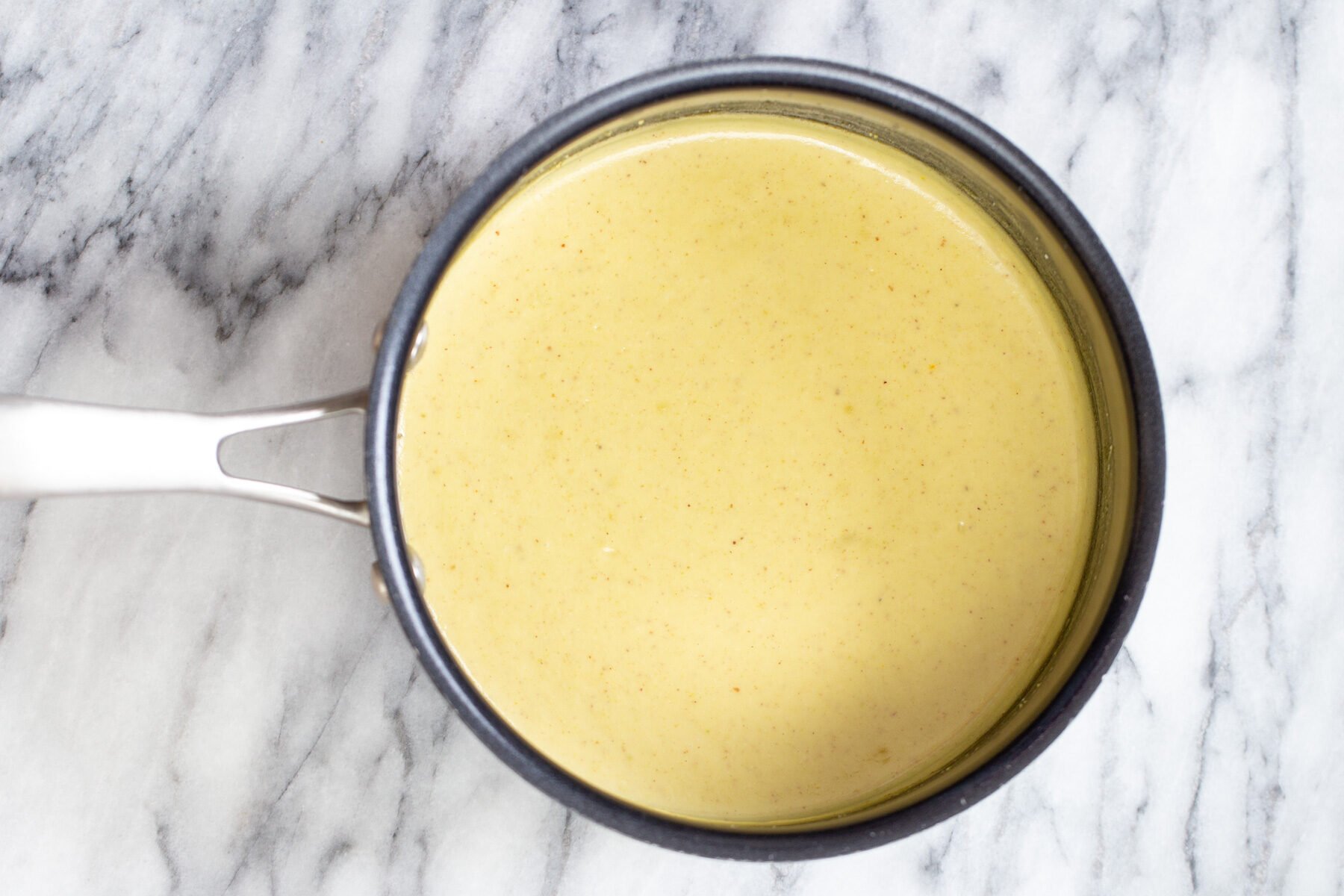 rabri recipe nut milk thickened with almond flour in a saucepan
