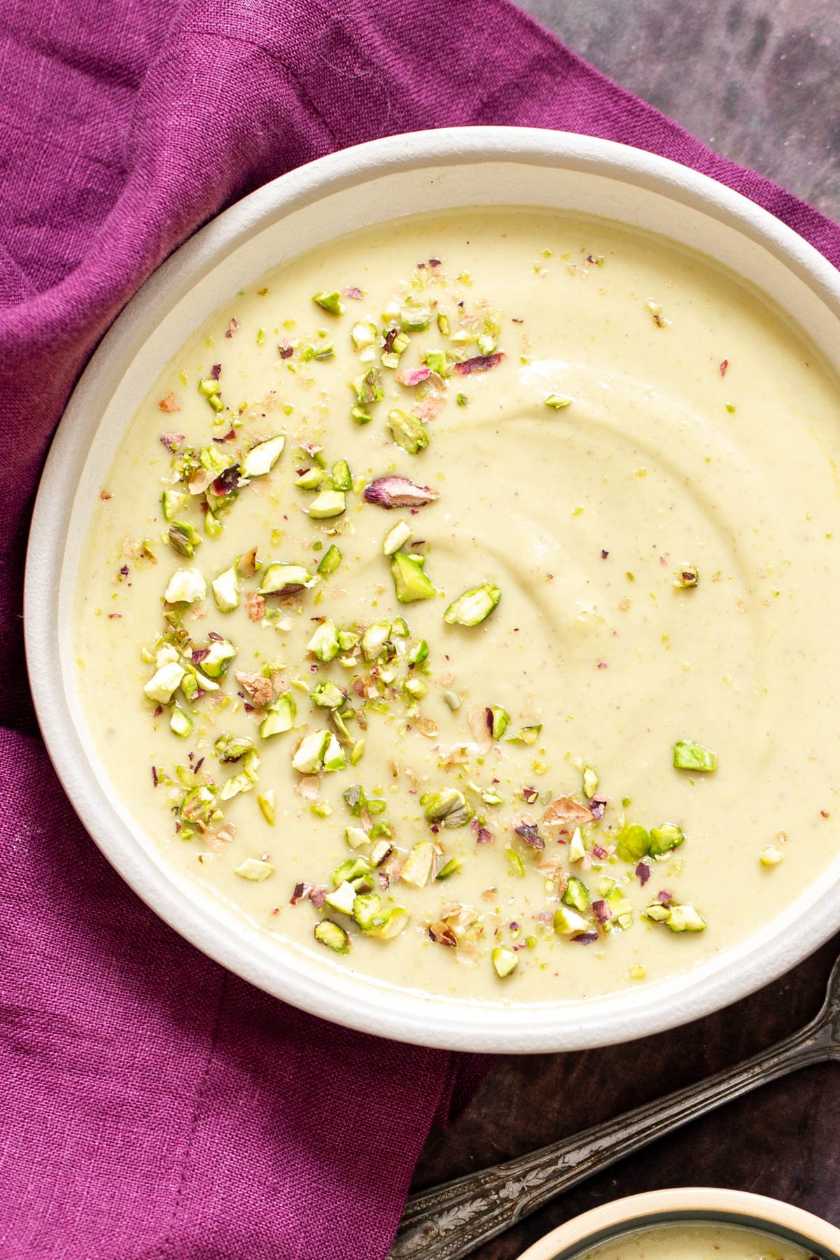 rabri recipe a bowl of Indian Rabri Pudding topped with chopped pistachios