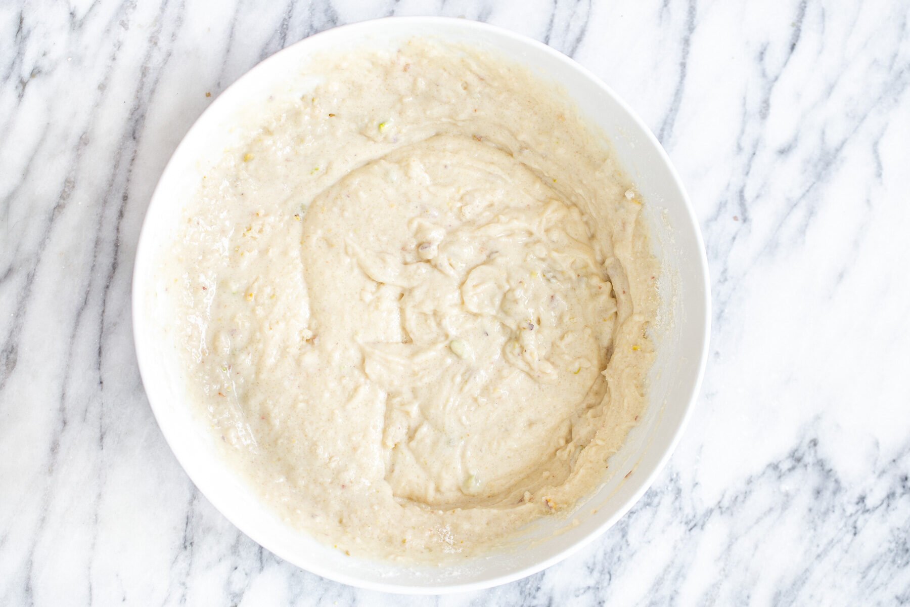 tres leches cake batter in a white bowl