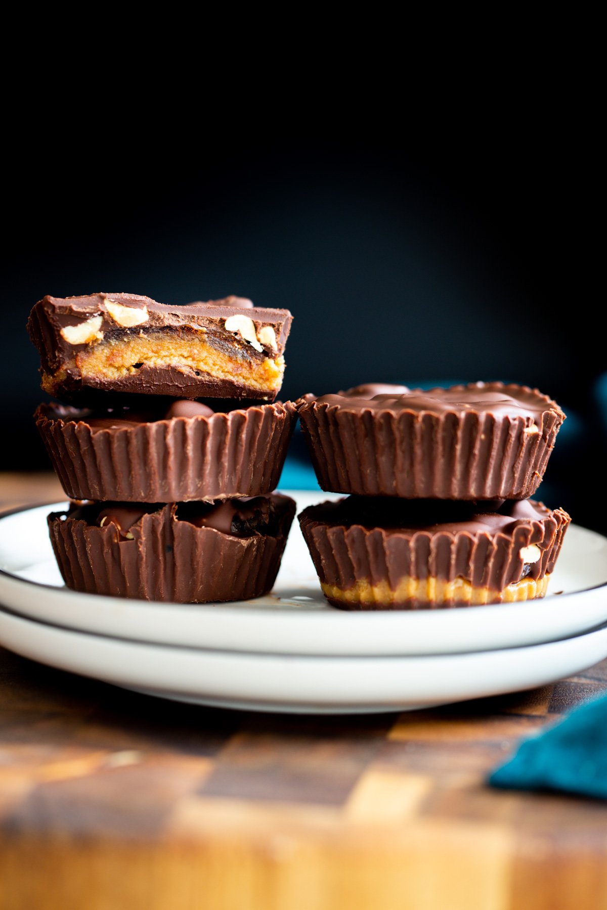 two stacks of vegan snickers peanut butter cups on a white plate