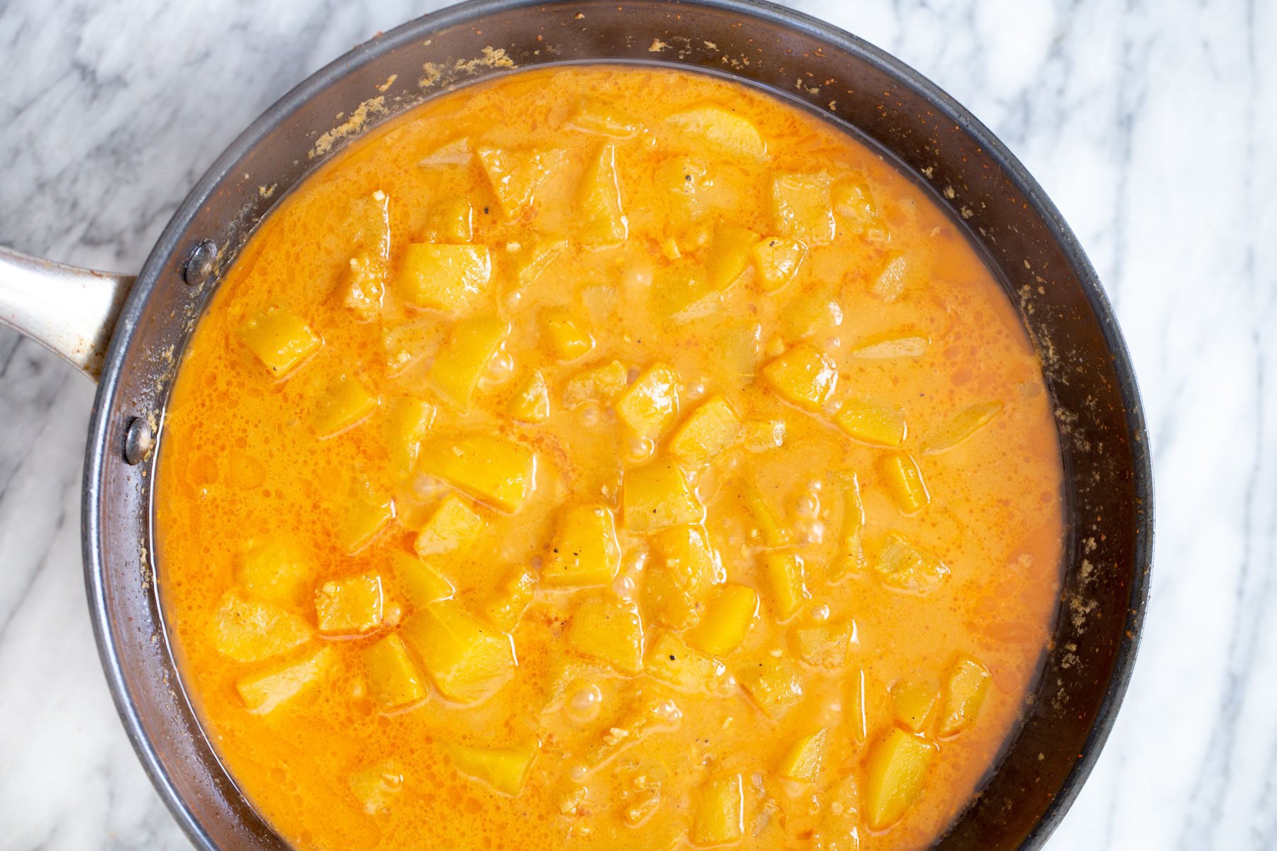 pumpkin simmering in Thai coconut curry broth