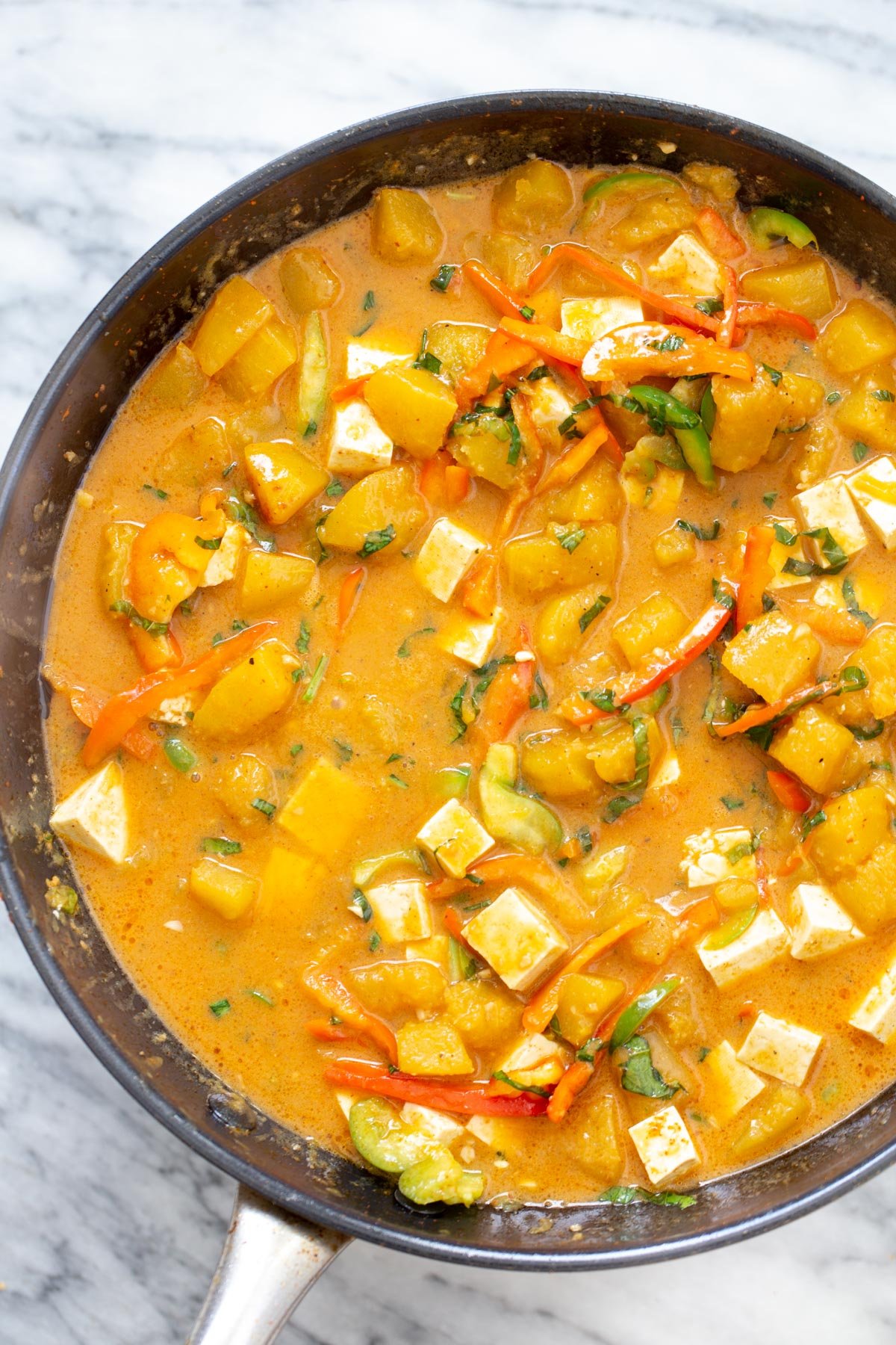 pumpkin curry with tofu cubes in a saucepan