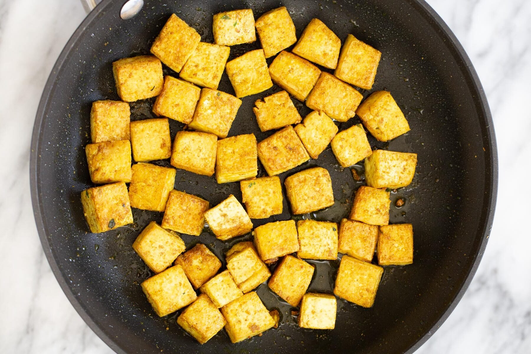tofu malai  tofu cubes being sauteed in a s frying pan
