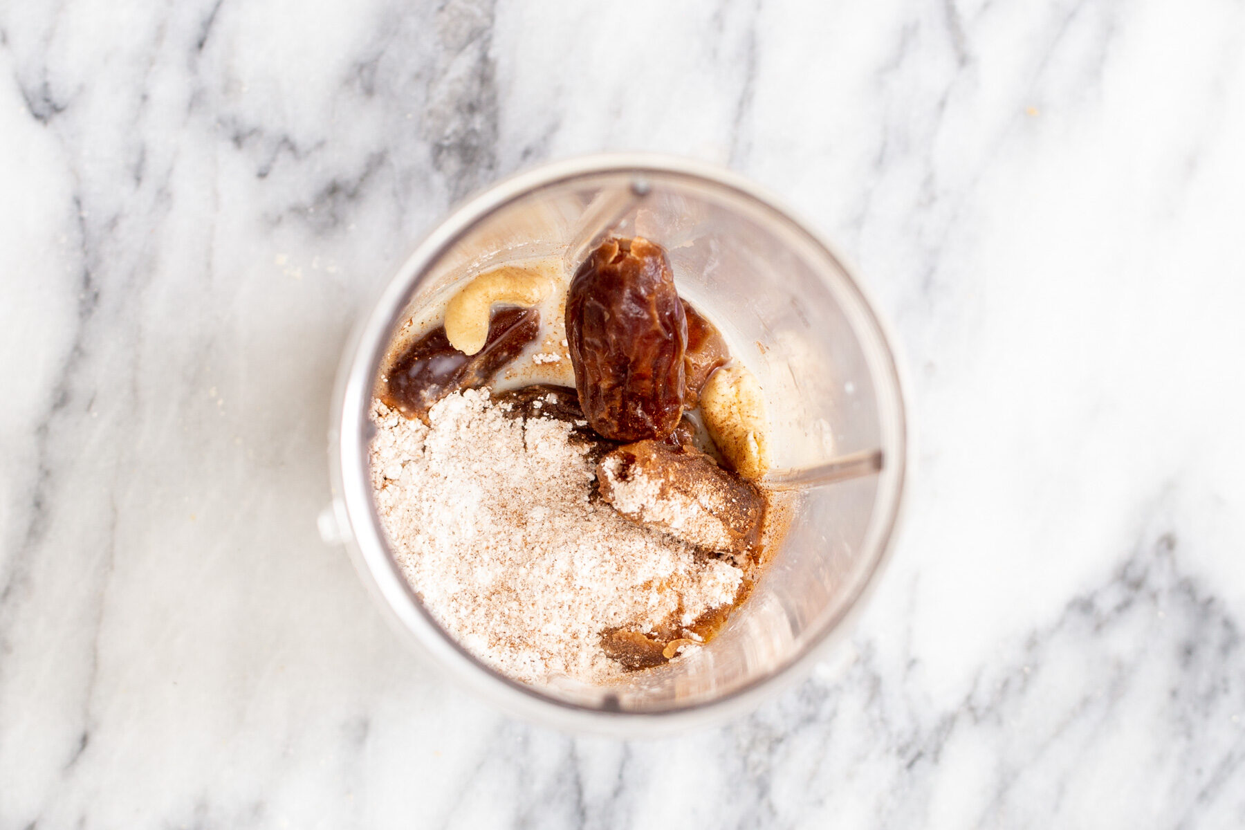 Vegan gluten-free pumpkin pie filling ingredients in a blender