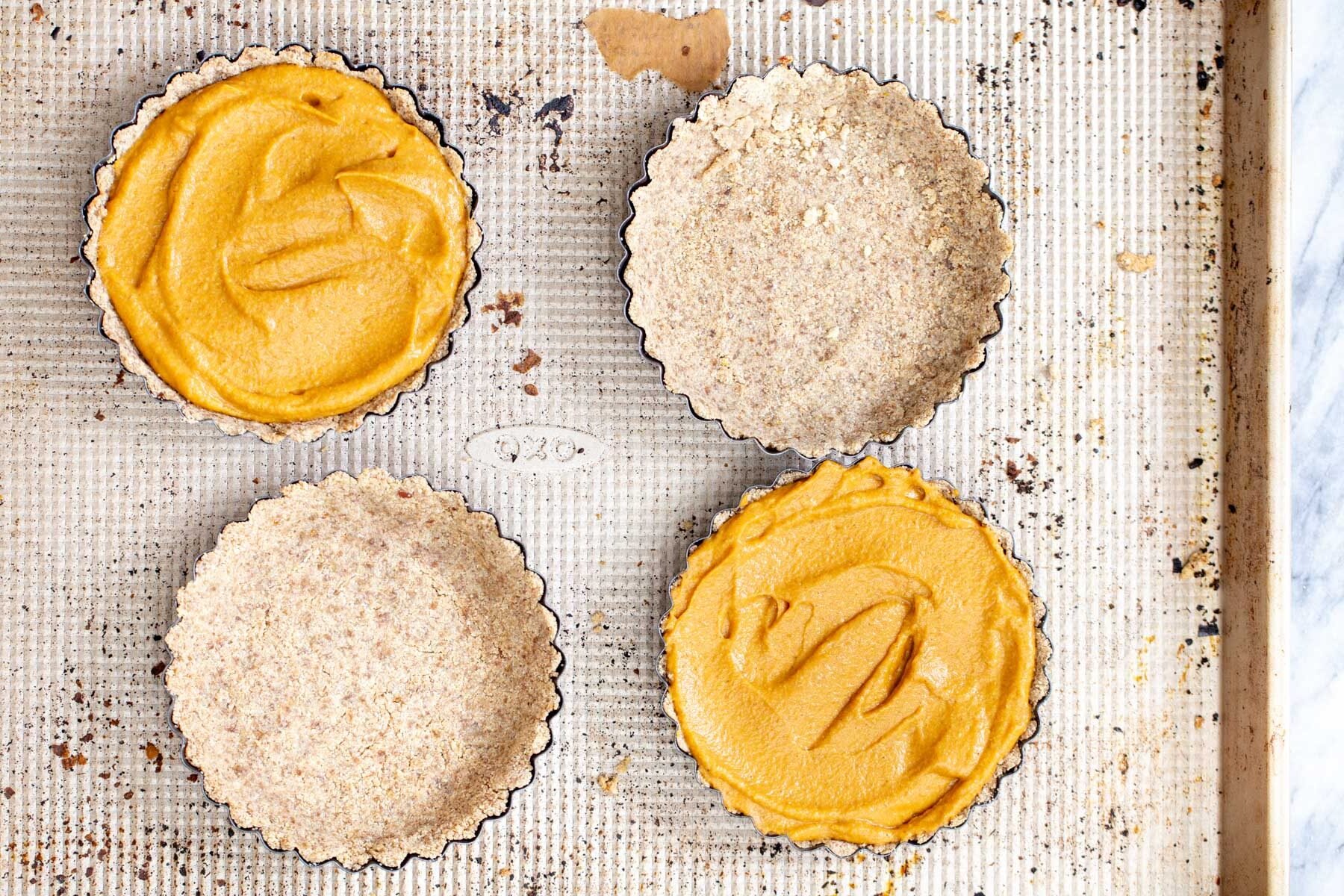 glutenfree vegan pumpkin pies individual pumpkin pies on a baking sheet