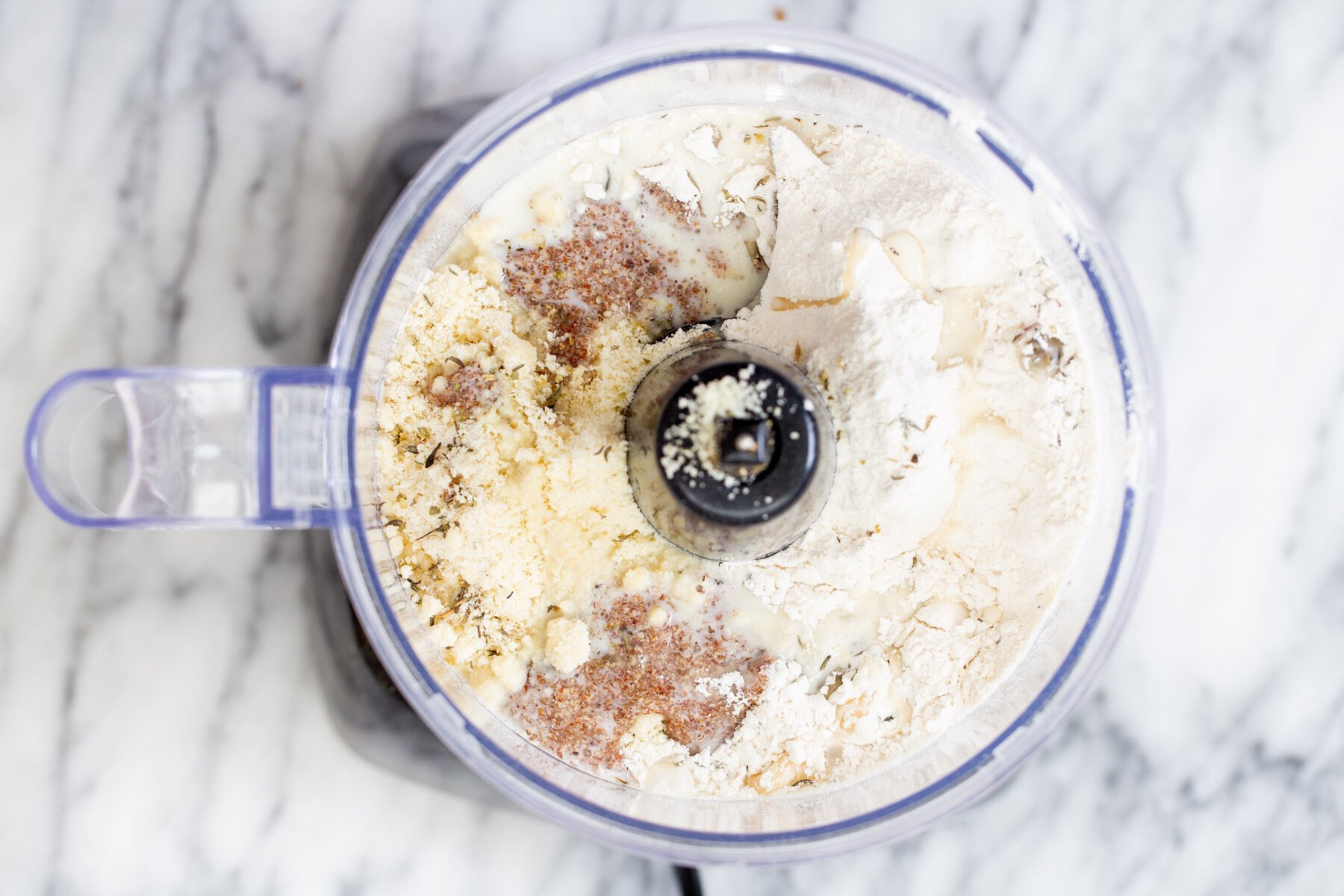 flax egg being added to vegan pie pastry in food processor