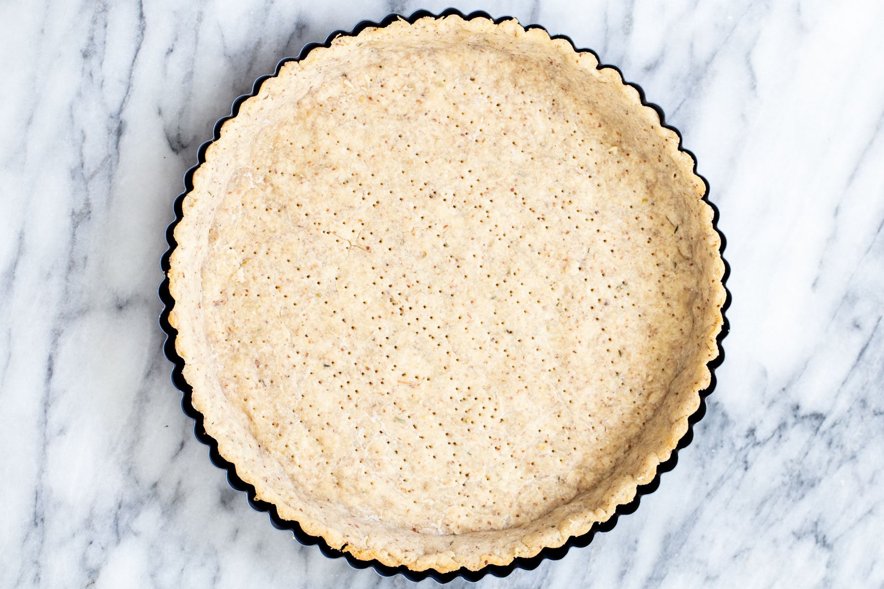 baked vegan almond flour pie pastry in a tarte pan