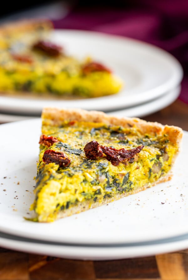 a slice of vegan quiche with spinach and leeks