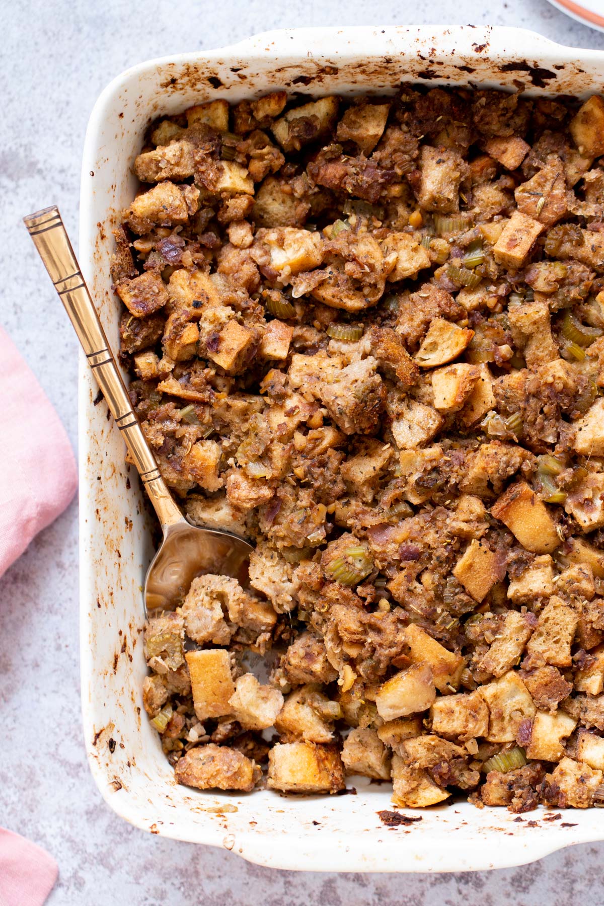 vegan stuffing a casserole dish with vegan stuffing with chickpea sausage
