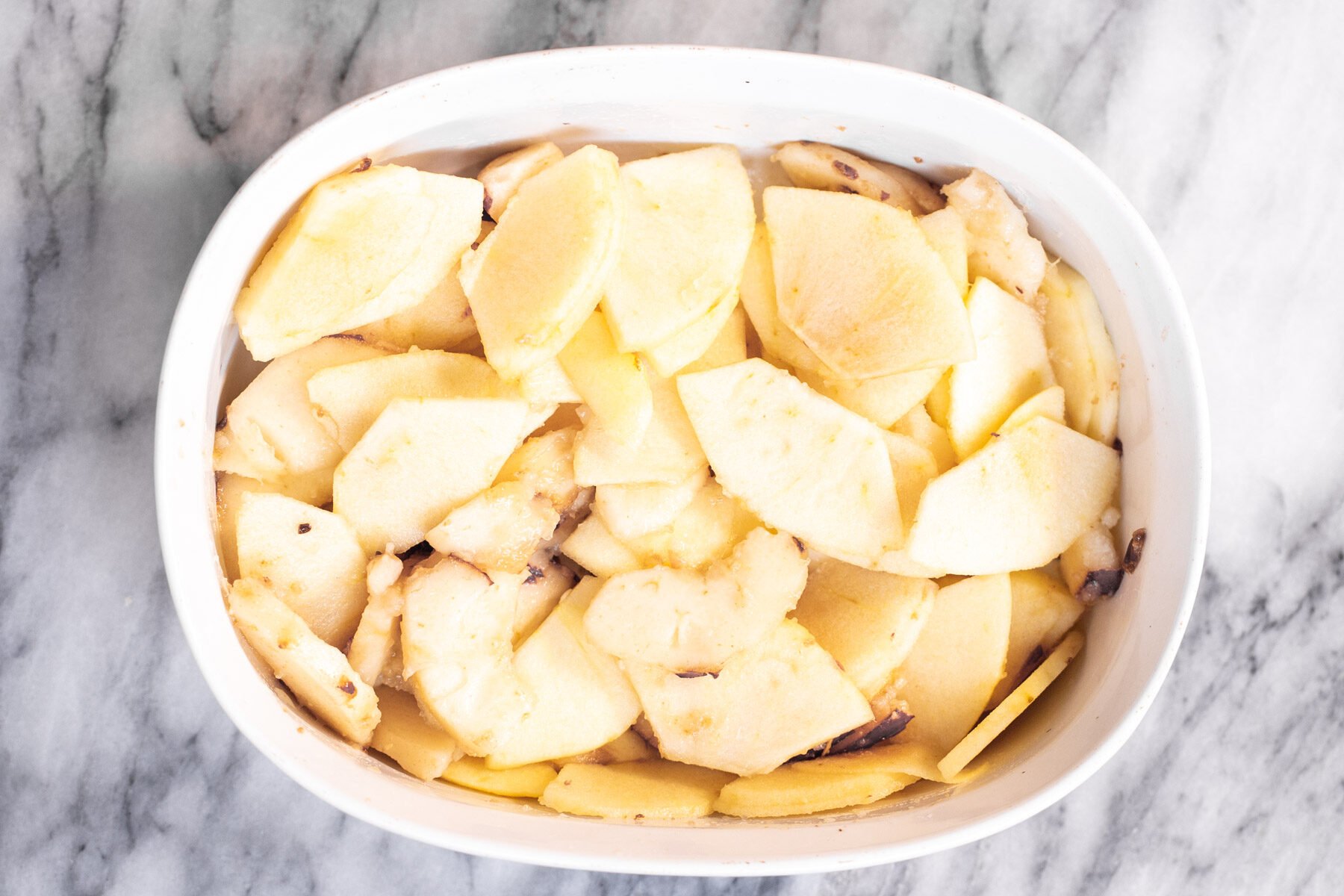 apple slices in a white casserole dish