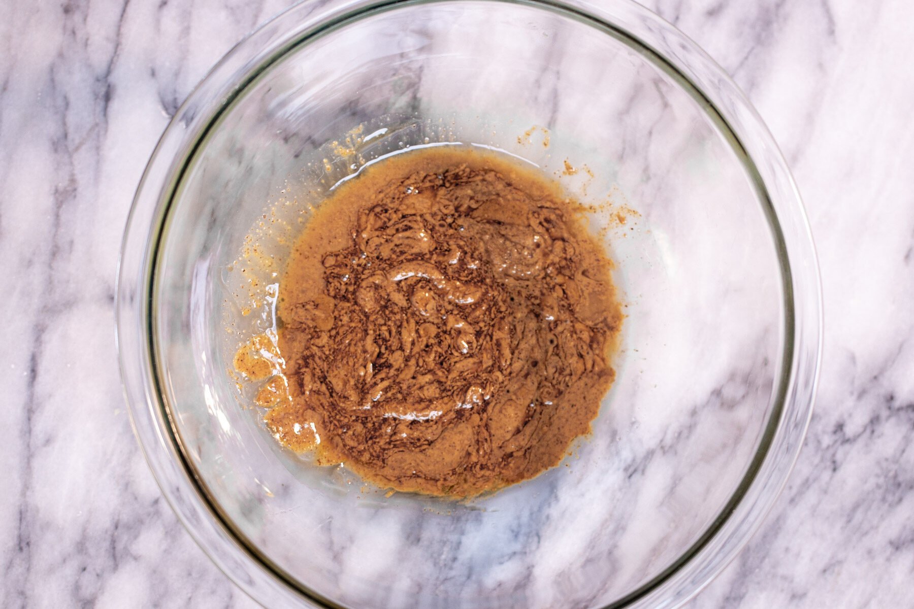 almond butter being mixed with oil to make crumble topping