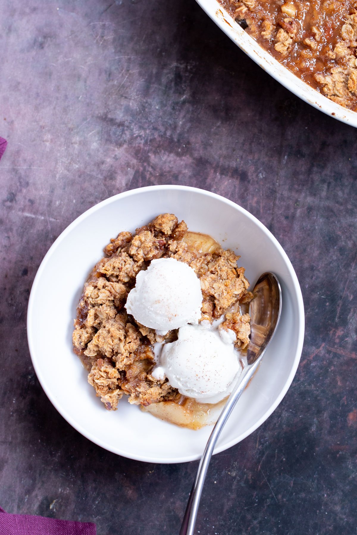 apple pear crisp a bowl of apple pear crisp with two scoops of ice cream