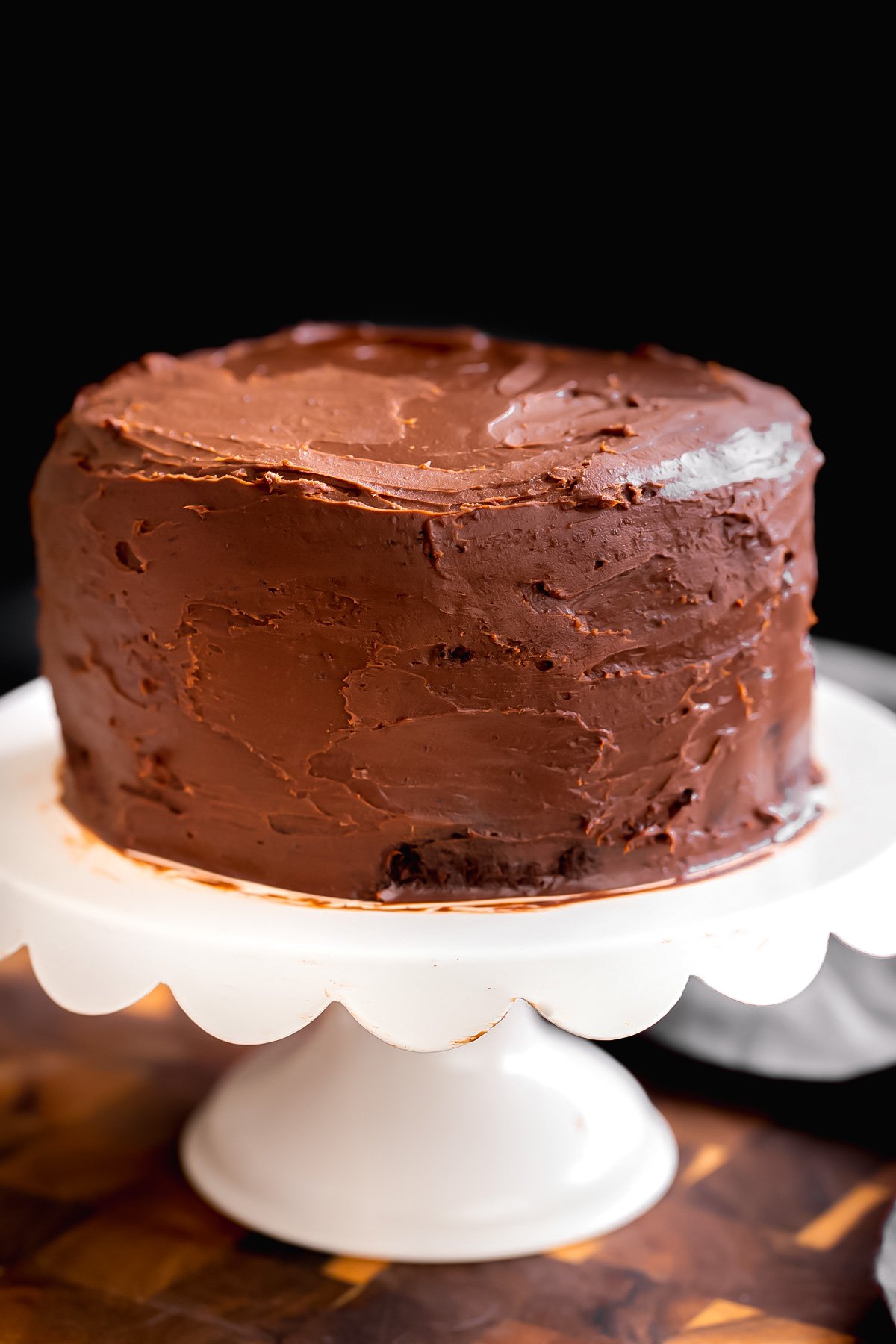 vegan glutenfree chocolate layer cake on a cake stand
