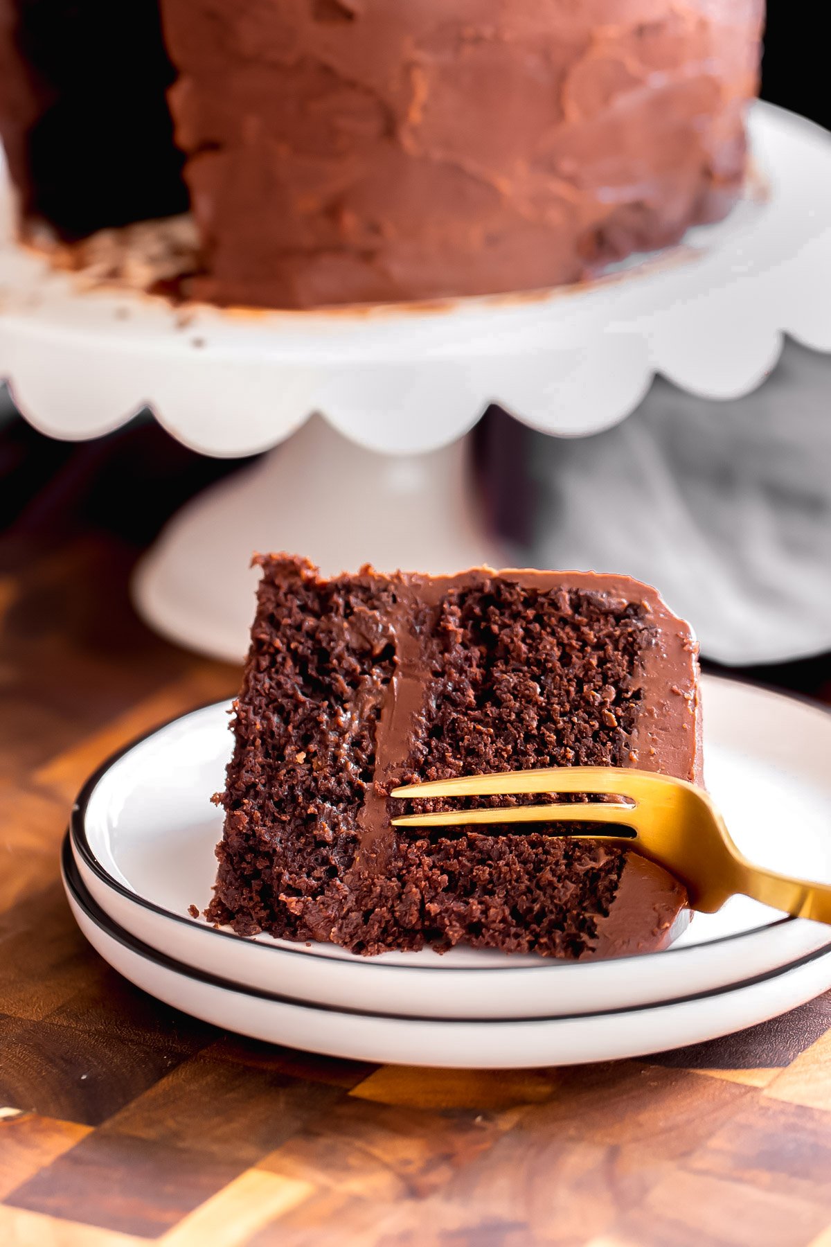 a fork being inserted into a slice of vegan glutenfree chocolate cake