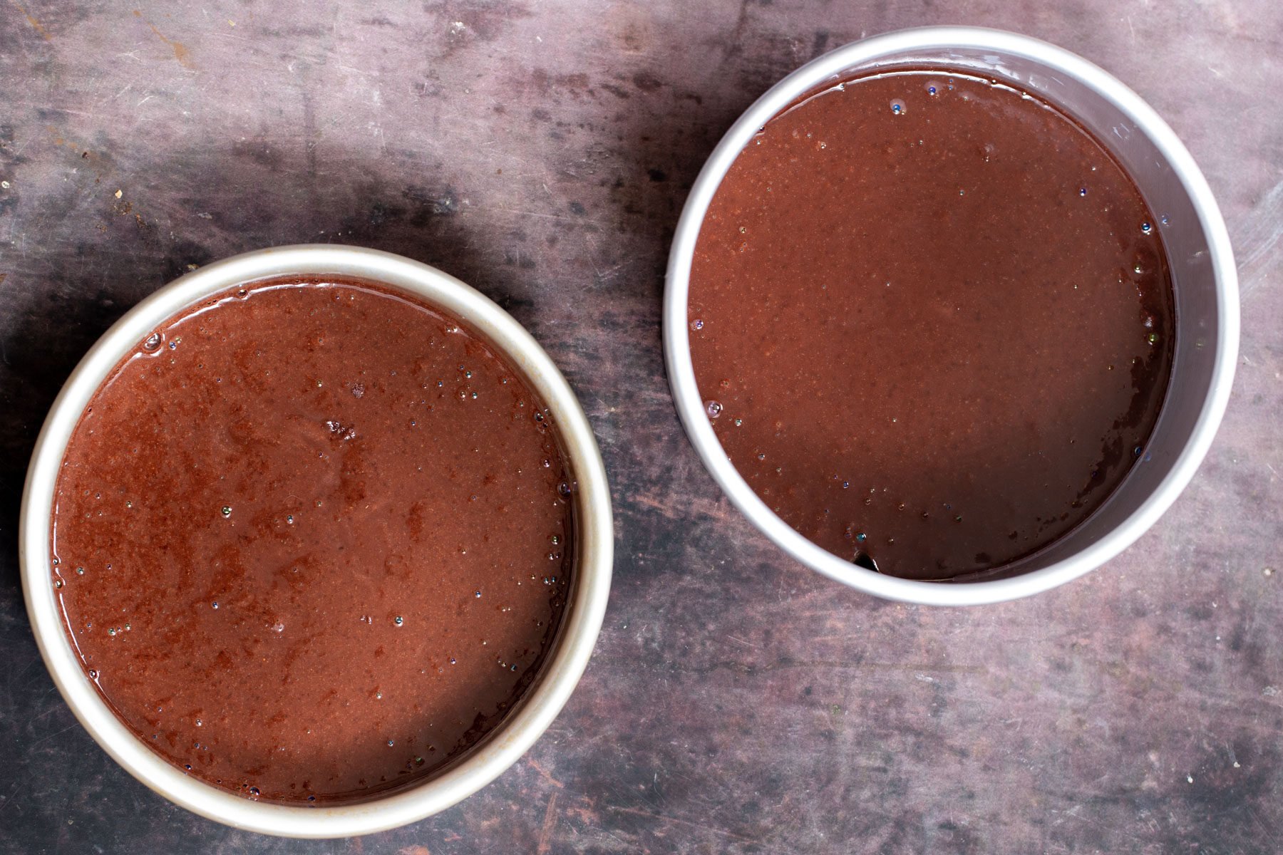 vegan chocolate cake batter in 2 cake pans