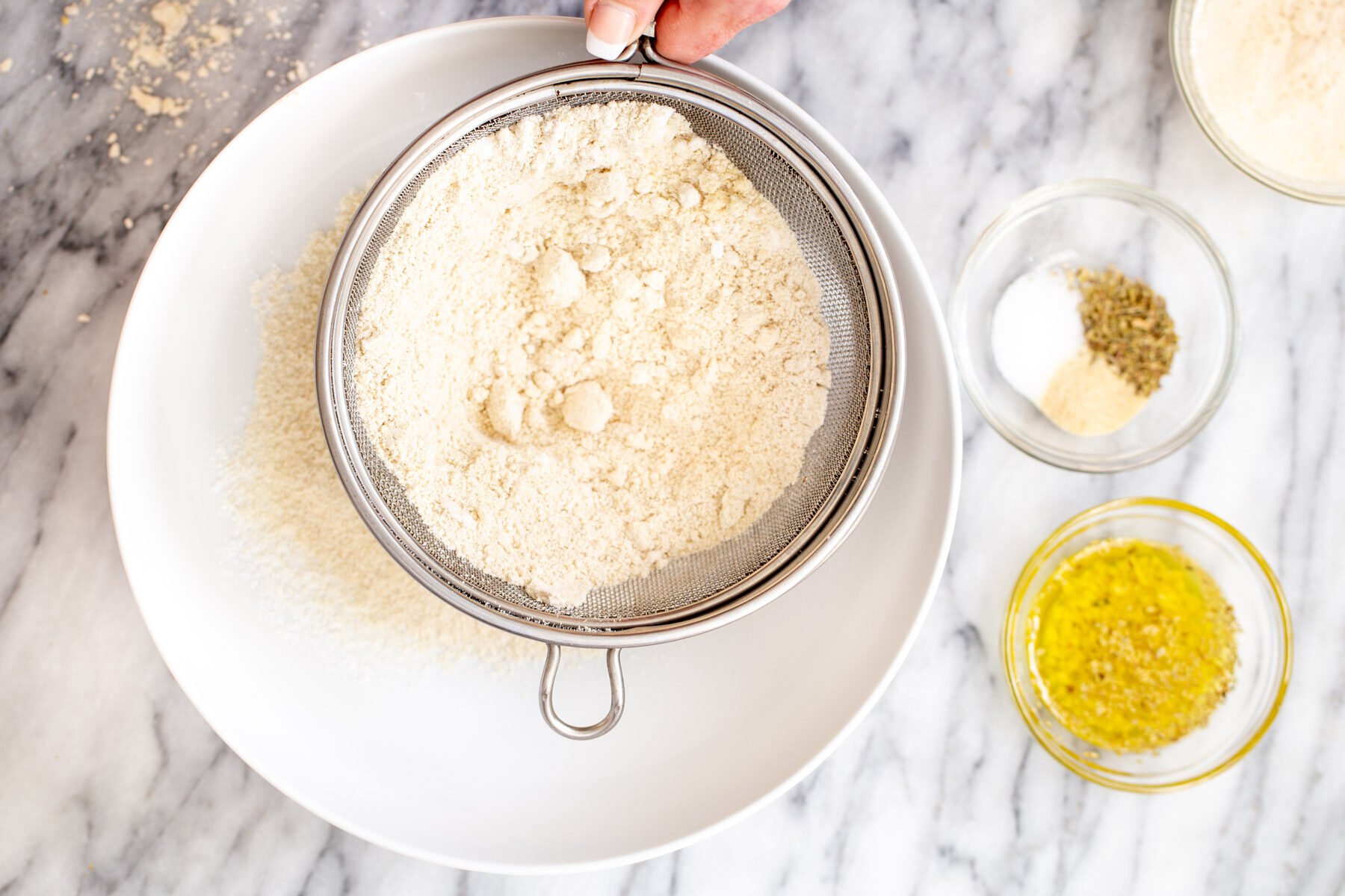 glutenfree focaccia  dry bread ingredients being sifted into a bowl