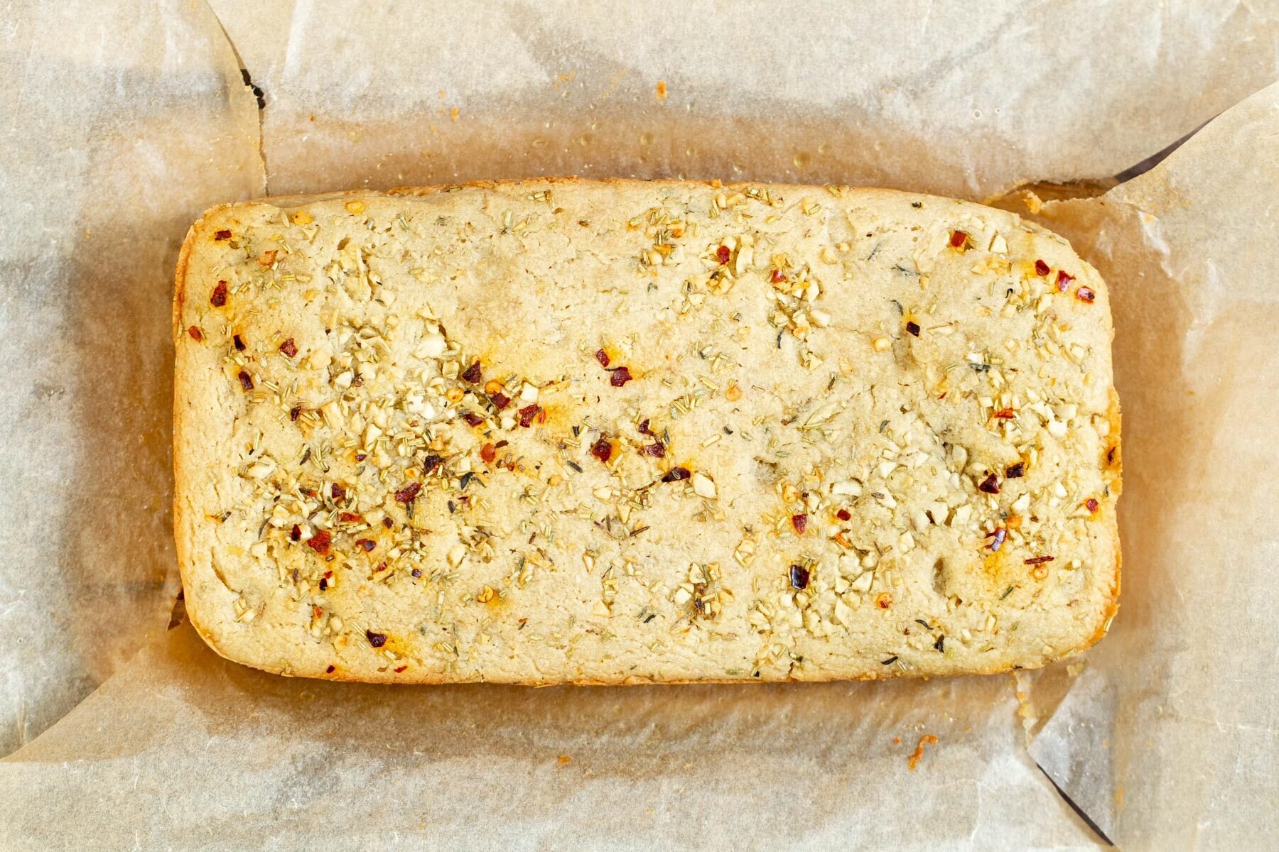 glutenfree focaccia  a loaf of glutenfree focaccia on parchment paper