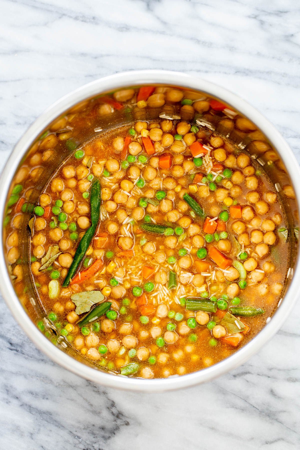 chickpea fried rice broth being added to dry ingredients to make chickpea fried rice