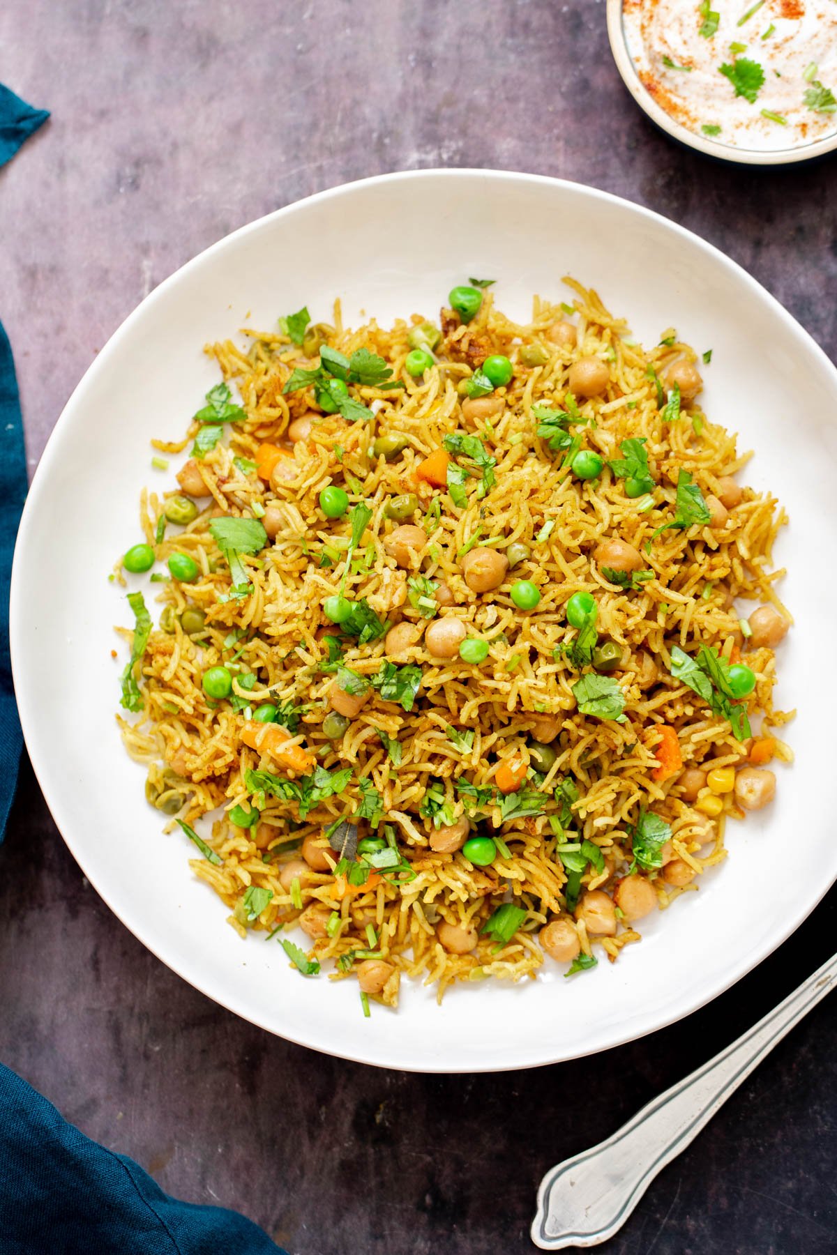 chickpea fried rice chickpea fried rice with peas and cilantro on a white plate