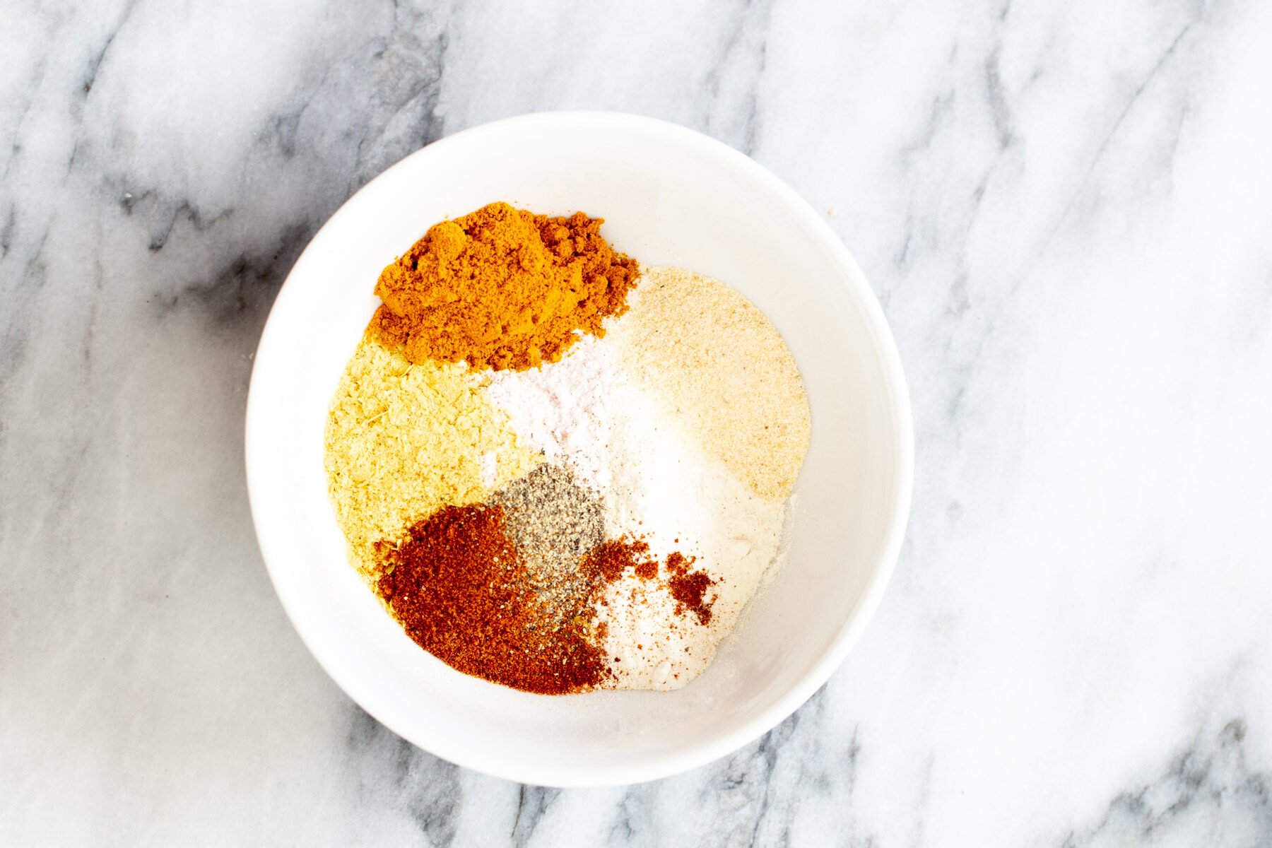 seasoning for tofu scramble in a white bowl