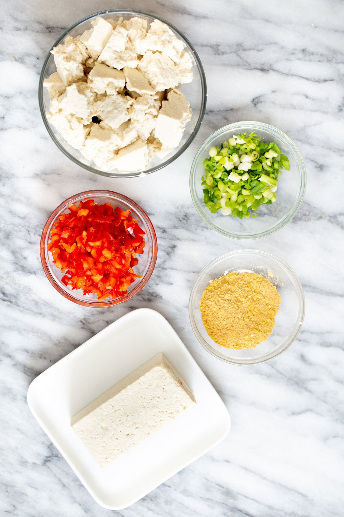 tofu scramble seasoning  ingredients for vegan tofu scramble on a marble countertop